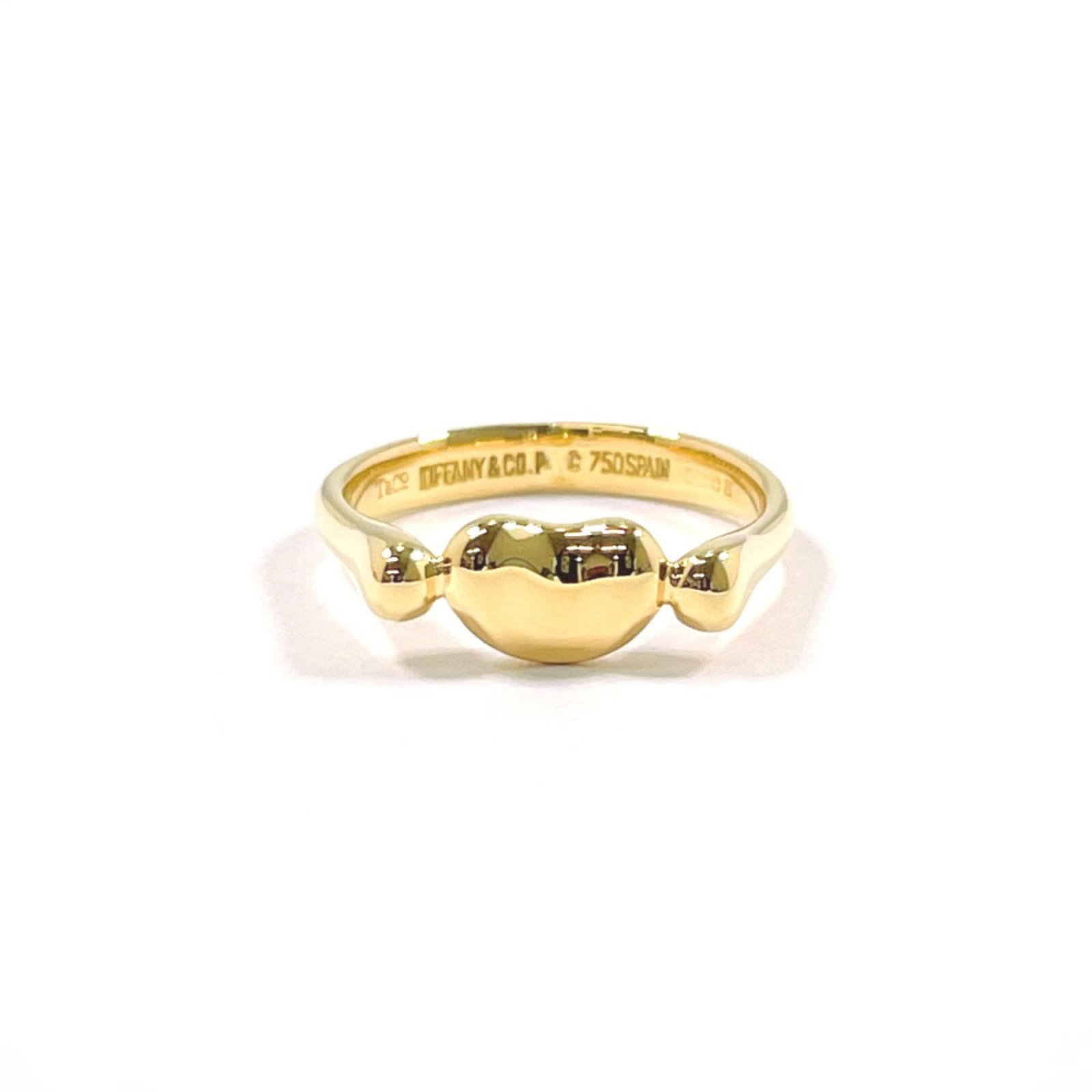 Yellow Gold 18K Tiffany Band Ring: Yellow Gold 18K Tiffany Band Ring Yellow gold band ring from Tiffany, crafted in Spain with 18K yellow gold material. This US size 5 ring features the iconic brand's signature style and design. A beau