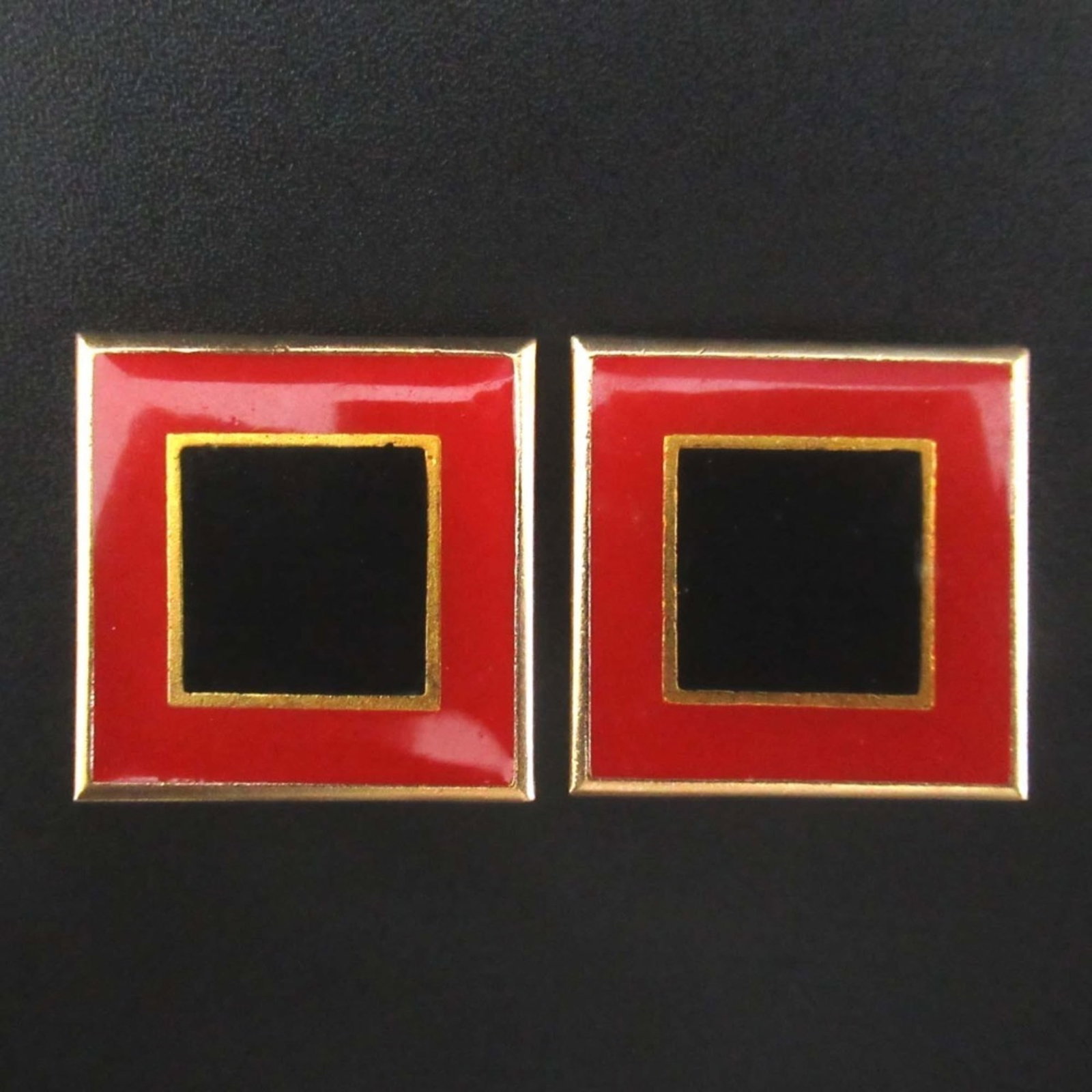 Saint Laurent Yves Clip Earrings: Saint Laurent Yves Clip Earrings Yves Saint Laurent's iconic clip earrings are a sleek and sophisticated accessory, featuring a striking black, gold, and red color combination that adds a pop of