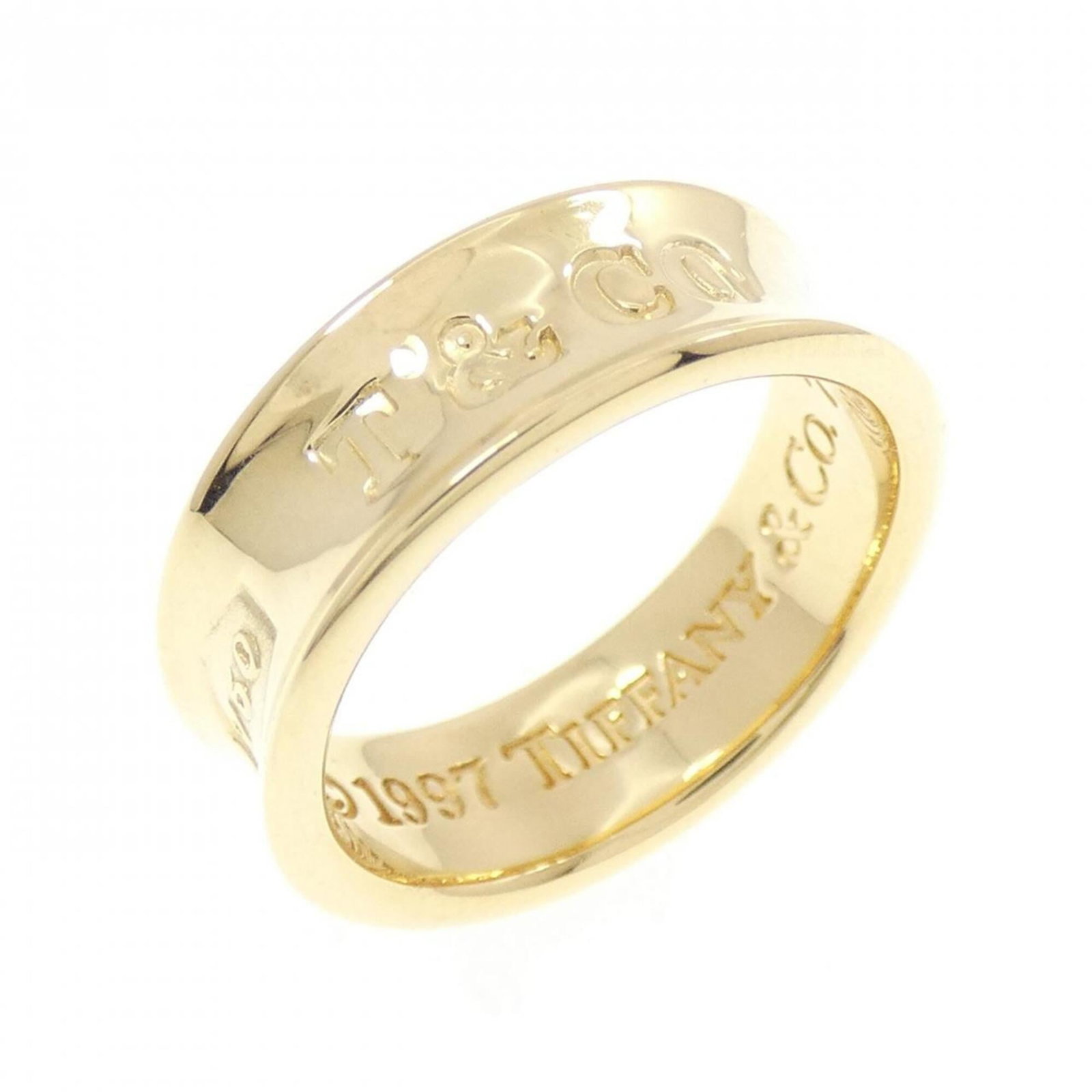 Yellow Gold 18K Tiffany Band Ring: Yellow Gold 18K Tiffany Band Ring Yellow gold (18K) Tiffany band ring, available in US size 5. This elegant ring features a classic design with yellow gold material and a signature on the inside. A ti