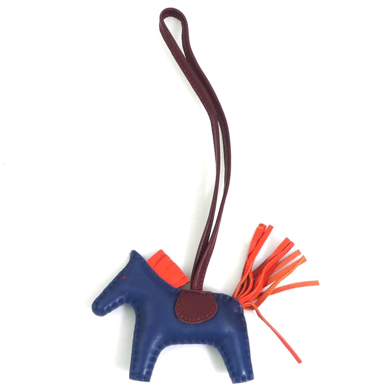 Hermes Charm Handbag Agneau Milo: Hermes Charm Handbag Agneau Milo Agneau Milo, the signature material from Herm?s, gives this charm handbag its unique texture and character. The vibrant blue, feu, and rouge hues add a pop of color to