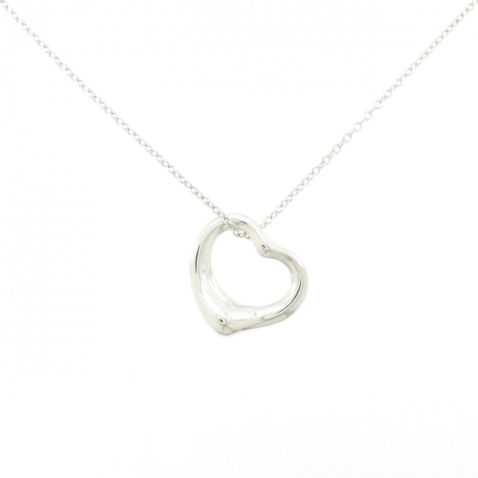 Open Heart Necklace by Tiffany: Open Heart Necklace by Tiffany The Open Heart Necklace by Tiffany features a beautiful silver pendant with a classic design, measuring 15.5mm x 14.7mm. This elegant necklace boasts a sterling silver