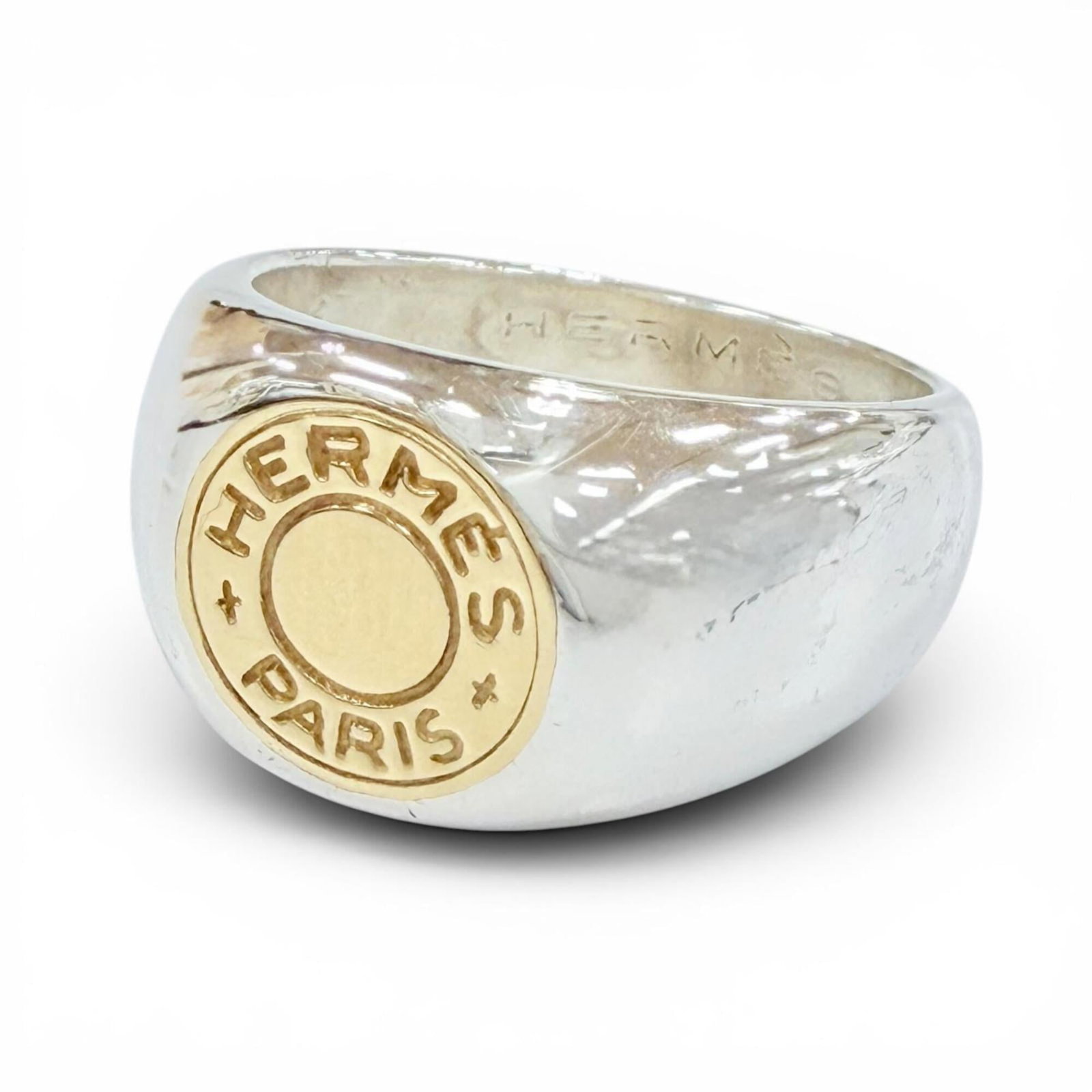 Hermes Band Ring Gold (18K) Silver 925: Hermes Band Ring Gold (18K) Silver 925 This 18K gold band ring features a sleek and modern design, paired with a silver 925 accent. The US size 6.5 ring offers a comfortable fit for women's hands. Mad