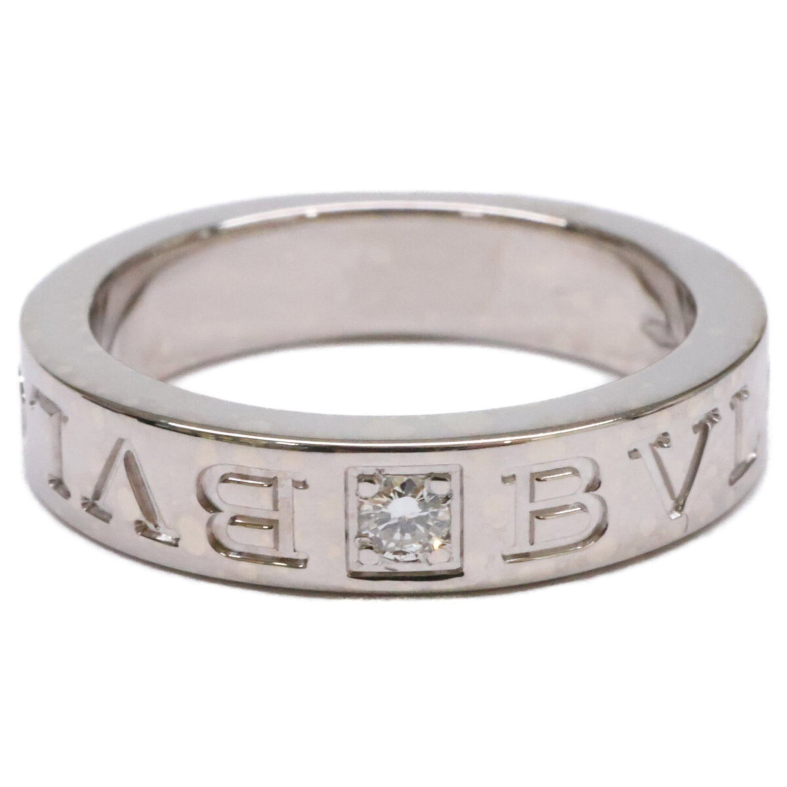 White Gold Bvlgari Ring Band: White Gold Bvlgari Ring Band White gold Bvlgari ring band, crafted from 18K white gold, features a diamond stone. This US size 4.5 band showcases the luxury brand's signature style. A timeless piece f