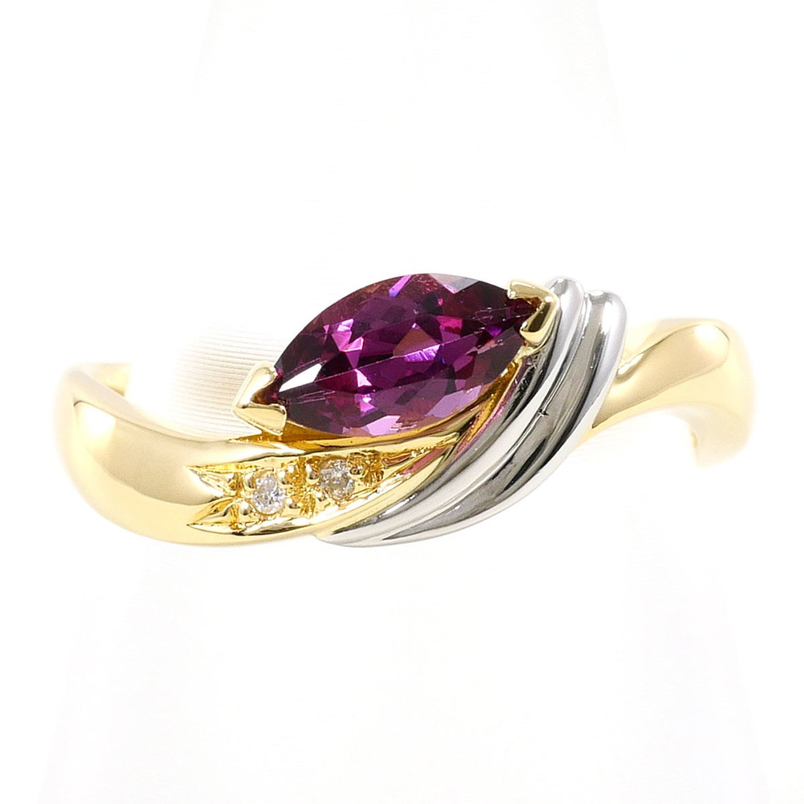 Unbranded Band Ring Platinum Yellow Gold (18K): Unbranded Band Ring Platinum Yellow Gold (18K) Platinum and yellow gold combine in this elegant band ring, featuring a subtle 18K metal purity. The ring showcases a diamond and garnet stone, adding a 