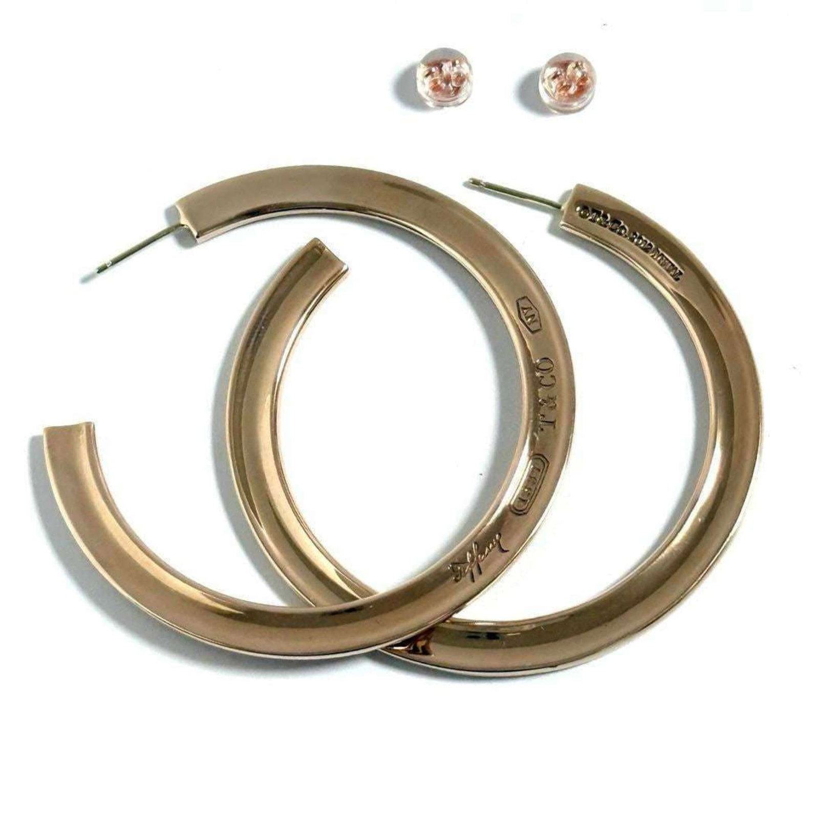 Hoop earrings alloy by Tiffany: Hoop earrings alloy by Tiffany Hoop earrings made from alloy by Tiffany, a well-known luxury jewelry brand. Alloy material provides durability and affordability, while the classic hoop design makes fo