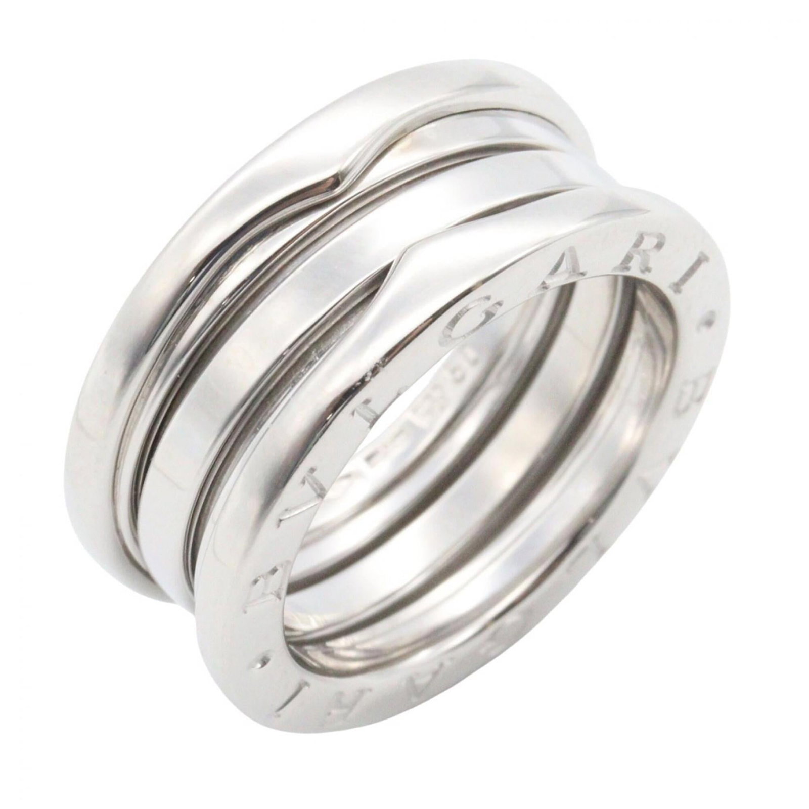 White Gold Bvlgari Ring Band: White Gold Bvlgari Ring Band White gold (18K) band ring from Bvlgari, available in US size 5. This silver band features the iconic Bvlgari brand and is made from high-quality white gold material. The 