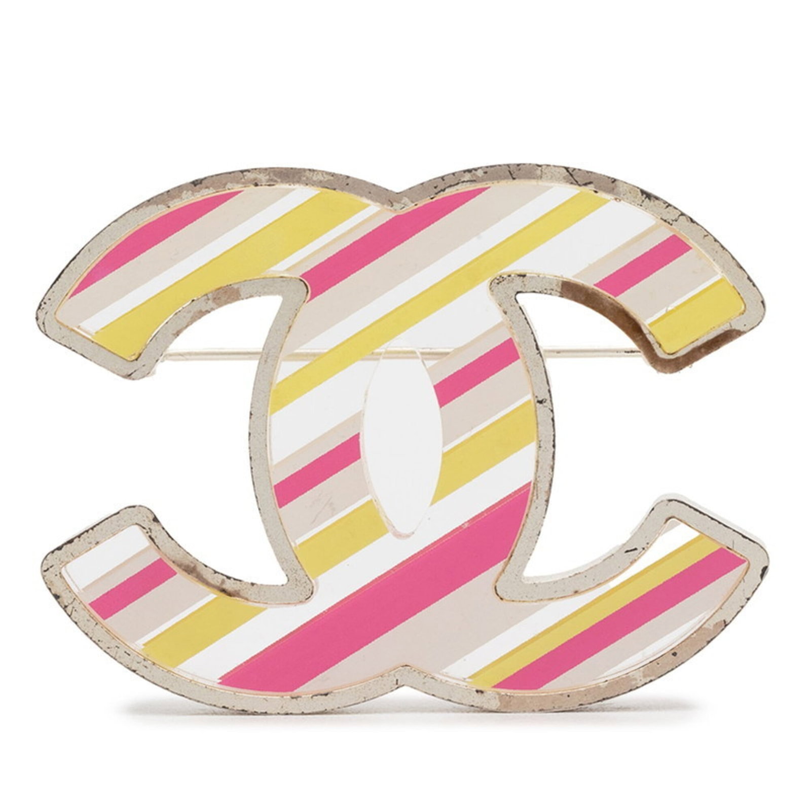 Metal brooch by Chanel: Metal brooch by Chanel Metal brooch by Chanel, featuring pink and silver tones with yellow accents, measures 4.07cm x 5.38cm / 1.6'' x 2.11''. This metal brooch bears a signature from the renowned fas