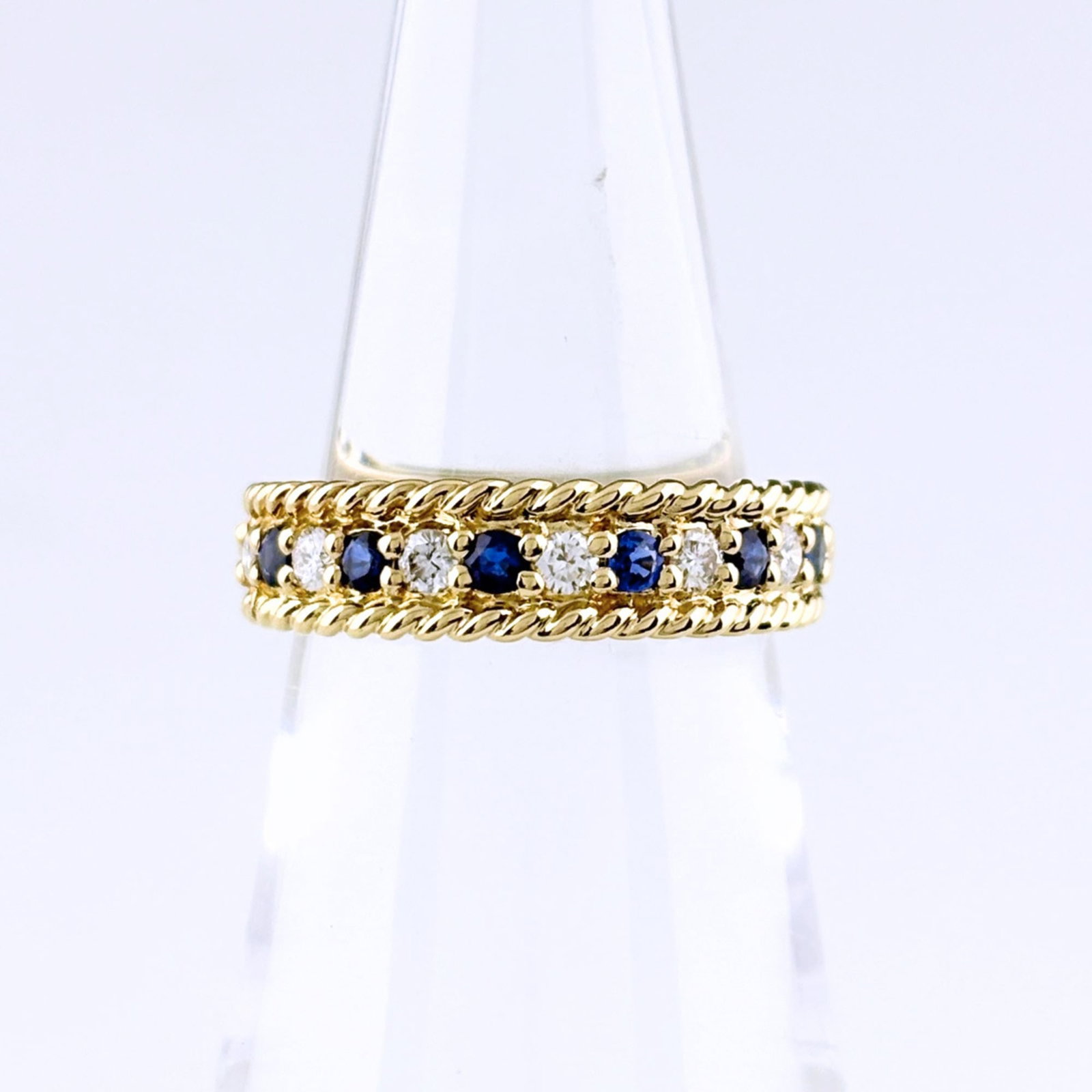 Dior Ring by Christian Band: Dior Ring by Christian Band This 18K gold band ring features a striking yellow diamond and sapphire combination, showcasing the craftsmanship of Christian Dior's design. The US size 5.5 ring boasts a 
