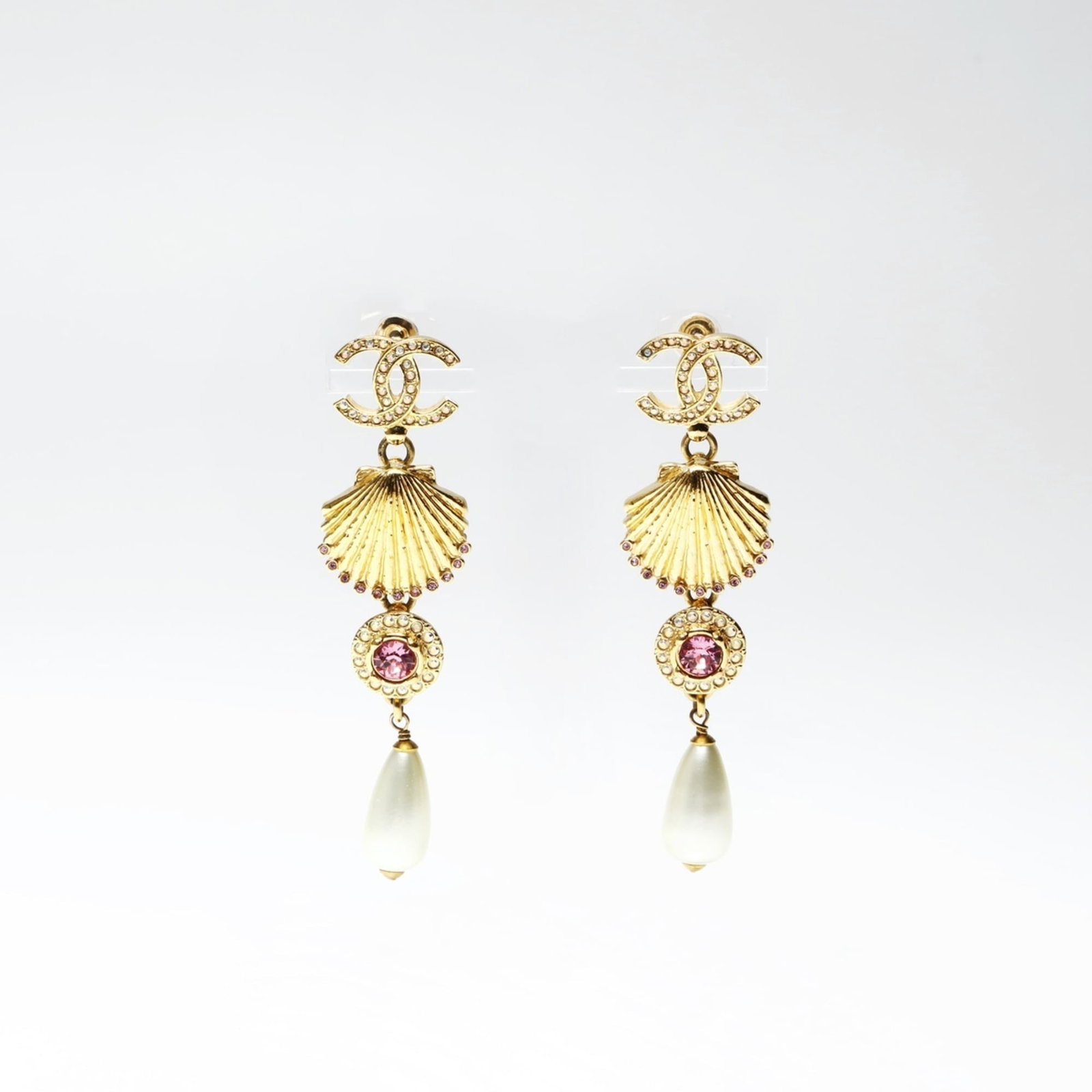 Chanel Drop Earrings: Chanel Drop Earrings Chanel Drop Earrings in Gold feature large pearl and rhinestone accents, adding a touch of elegance to any outfit. Measuring 65mm x 16mm, these statement earrings are sure to make