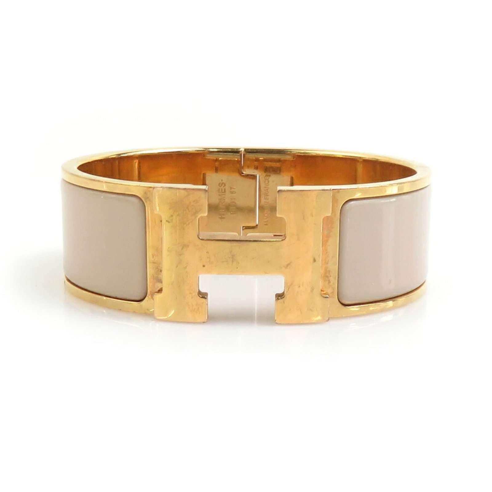 Hermes Bangle Enamel Metal: Hermes Bangle Enamel Metal Gold and grayish enamel metal bangle from Hermes, measuring 16cm in length and 2cm in width. This stylish accessory features a classic design with a subtle color combination