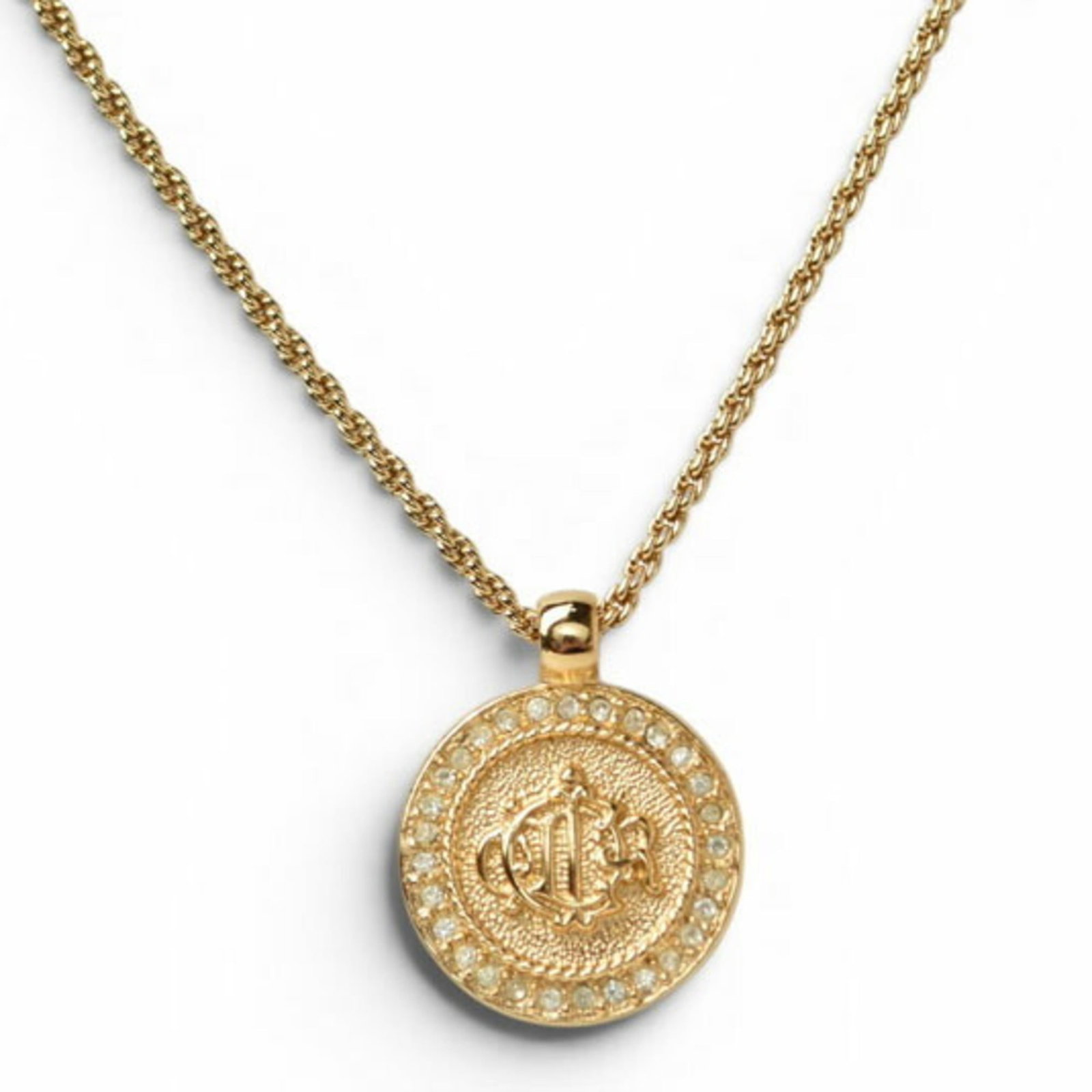 Christian Dior Necklace With Emblem And Rhinestones Gold.: Christian Dior Necklace With Emblem And Rhinestones Gold. Gold-plated Christian Dior necklace features an emblem and rhinestones, available in sizes 38-44 cm. The pendant measures 22mm x 22mm and is s