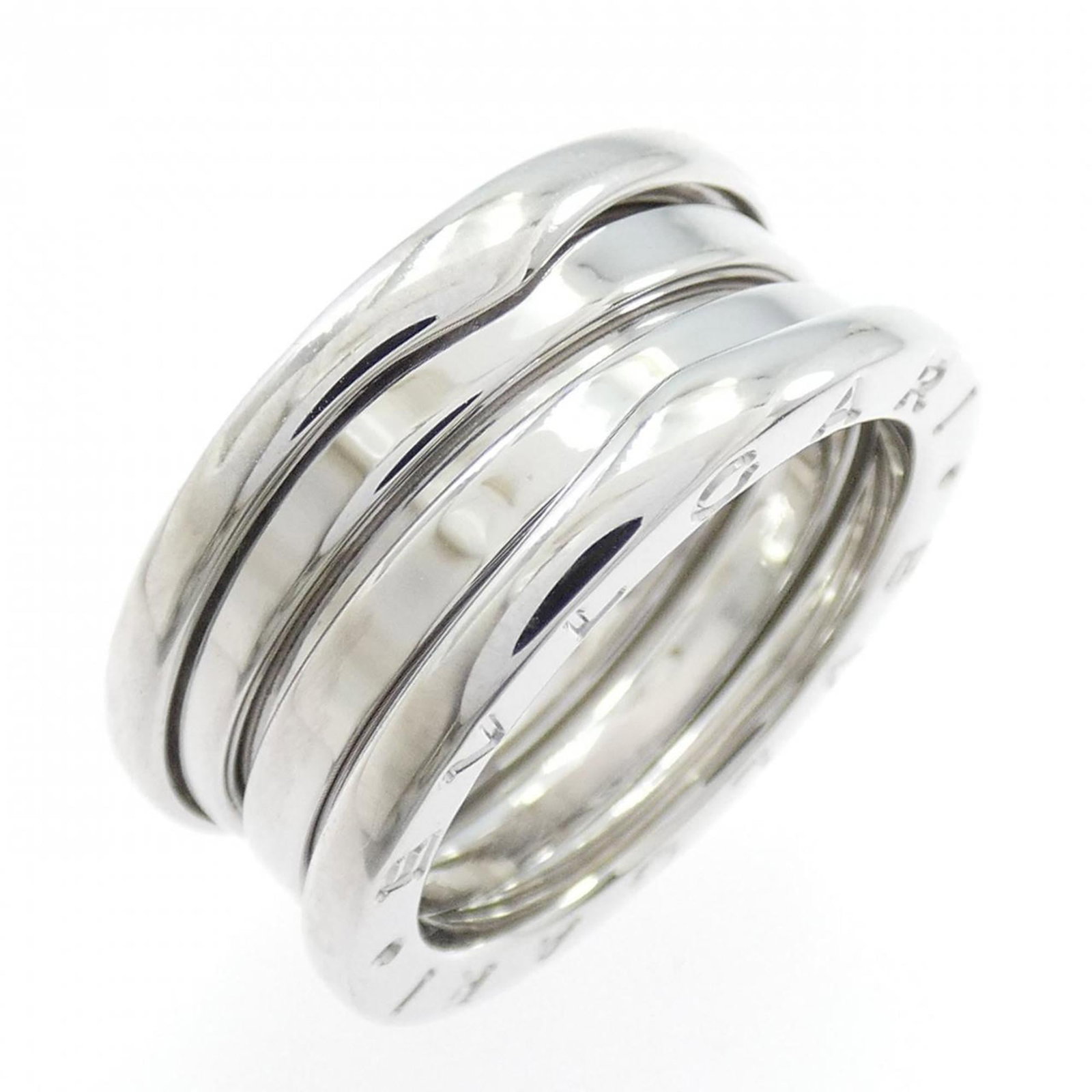 White Gold Bvlgari Ring Band: White Gold Bvlgari Ring Band White gold (18K) band ring from Bvlgari, featuring a sleek and sophisticated design. This 52 US size, 6.5 band ring boasts a striking white gold finish that adds a touch