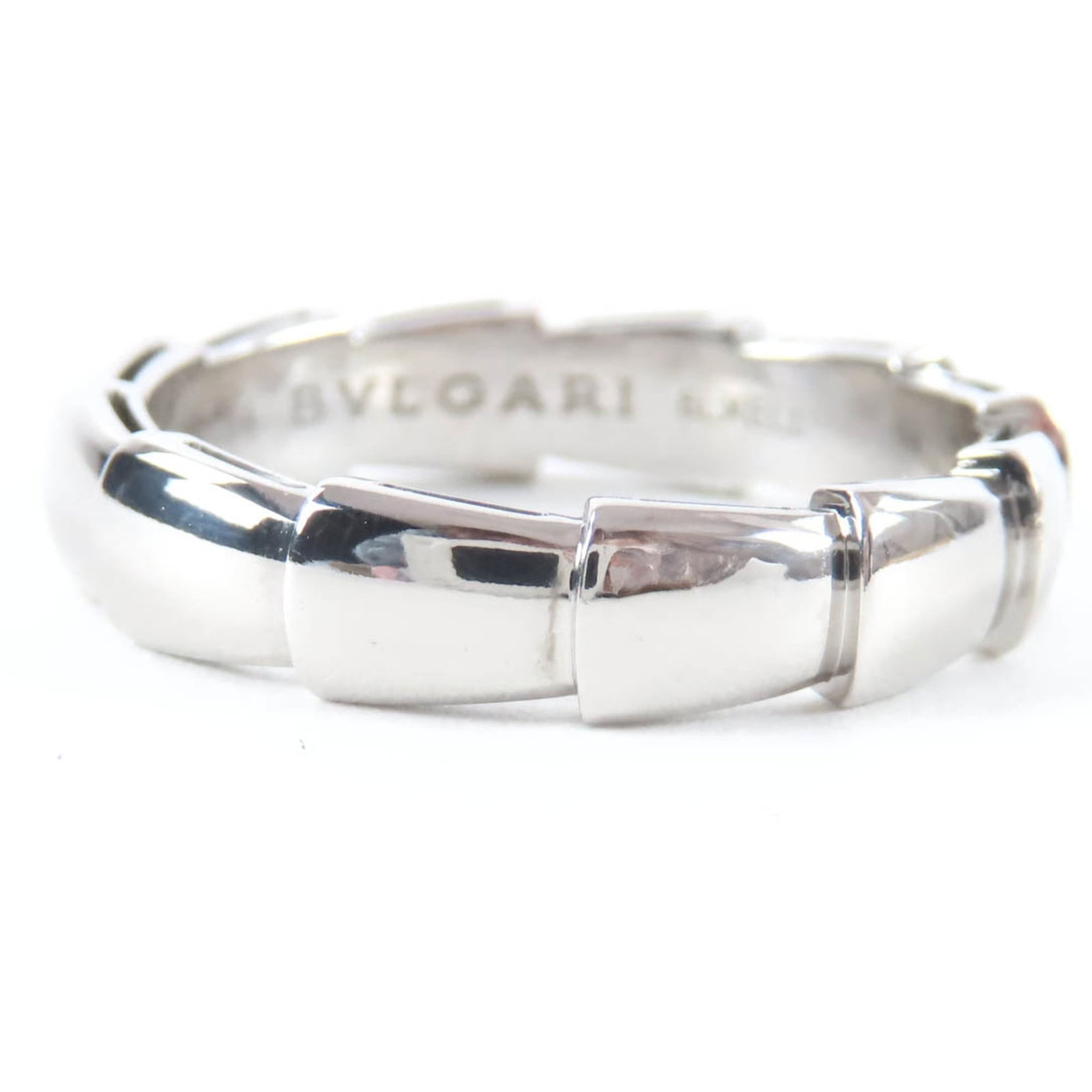 White Gold Bvlgari Ring Band: White Gold Bvlgari Ring Band White gold Bvlgari ring band, crafted from 18K white gold, features the iconic Italian brand's signature style. This elegant band boasts a classic design with a silver fin