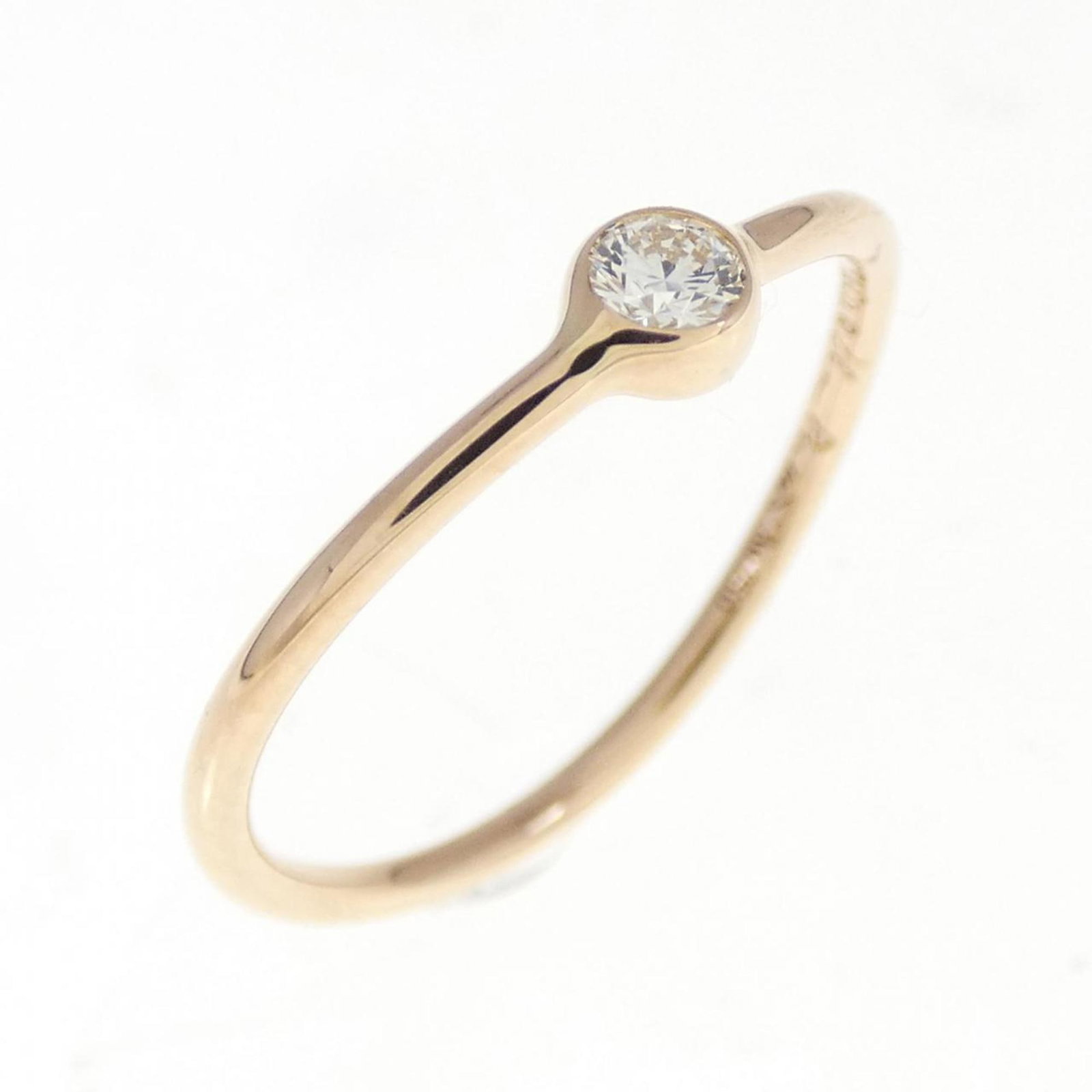 Pink Gold Tiffany Ring Band: Pink Gold Tiffany Ring Band Pink gold (18K) Tiffany ring band with a diamond stone, available in US size 4.5 and no additional accessories. This elegant band showcases the luxury of pink gold craftsma