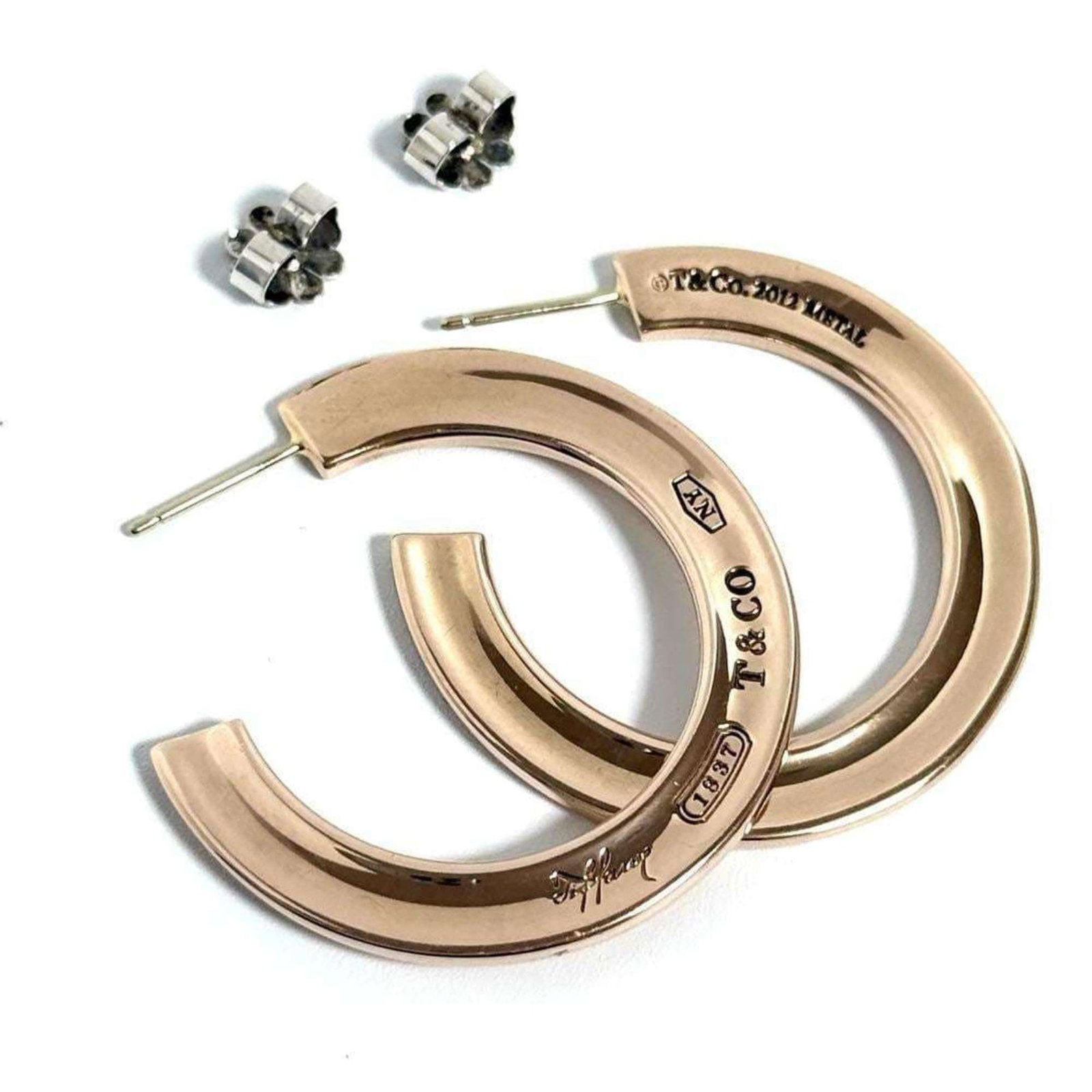 Tiffany Hoop Earrings Metal: Tiffany Hoop Earrings Metal Tiffany's iconic hoop earrings are crafted from metal, making them a timeless and versatile accessory for women. The elegant design features no additional accessories, allo