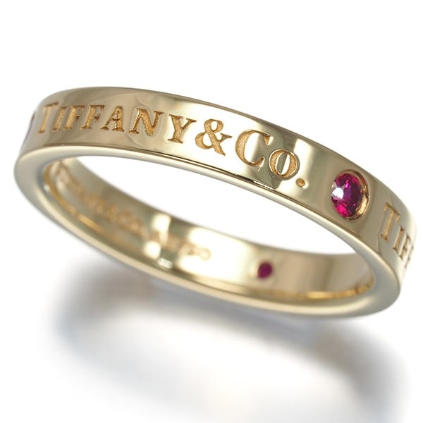 Ruby 750 18K 4.25-4.5 Yellow Gold Ring Flat Band Tiffany&Co: Ruby 750 18K 4.25-4.5 Yellow Gold Ring Flat Band Tiffany&Co 18k yellow gold ring flat band from Tiffany & Co, featuring a natural ruby stone. This elegant piece boasts a classic design with a subtle