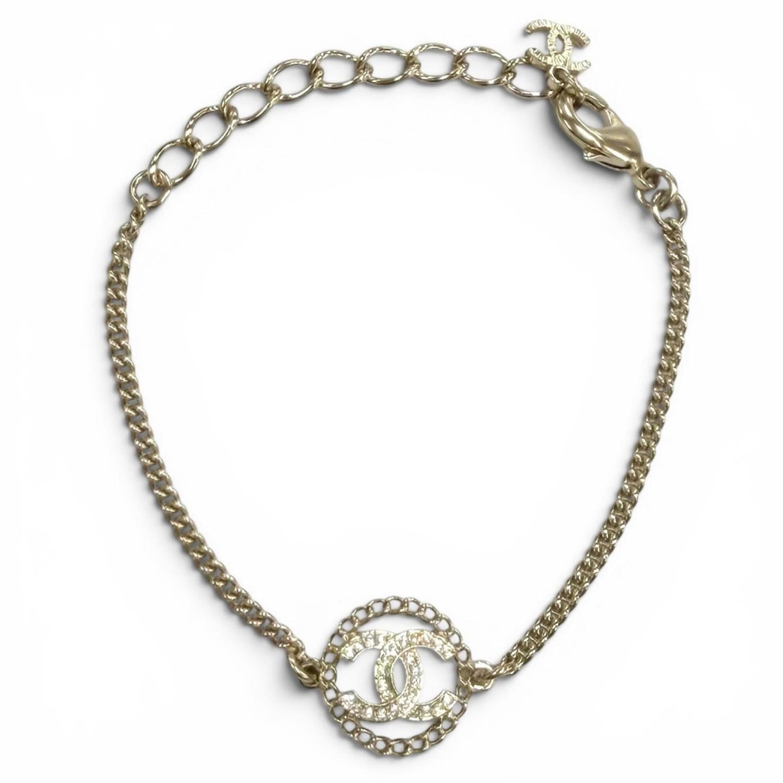 Charm bracelet from Chanel: Charm bracelet from Chanel Chanel's iconic charm bracelet features a delicate gold design adorned with sparkling rhinestones, adding a touch of elegance to any outfit. Measuring approximately