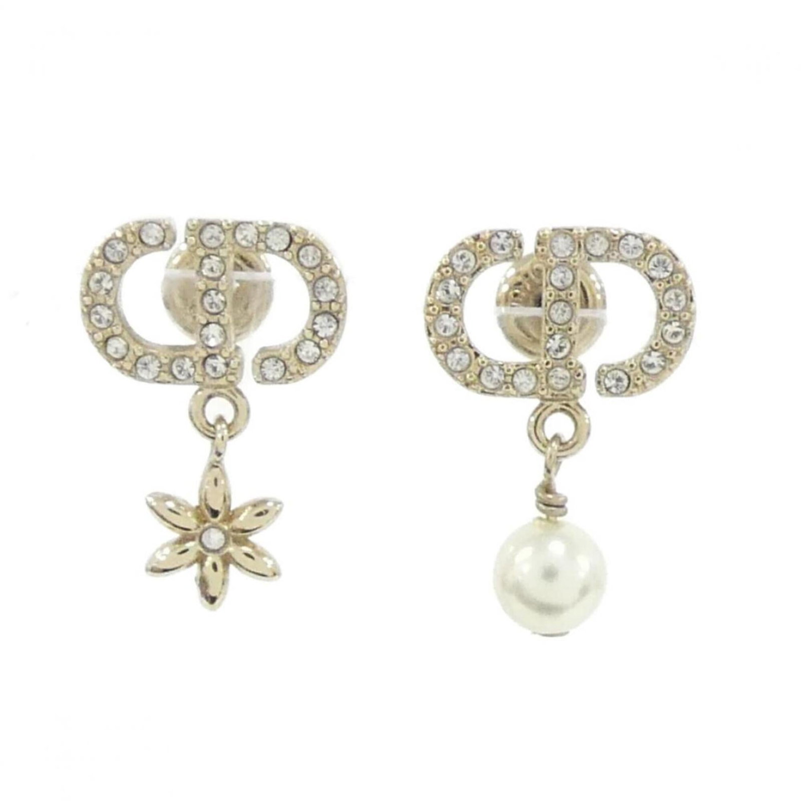 Stud earrings by Christian Dior: Stud earrings by Christian Dior Stud earrings by Christian Dior feature clear, gold, and white details. The item measures 18.00mm x 12.00mm with a diameter of 0.71'' and width of 0.47''. These stud