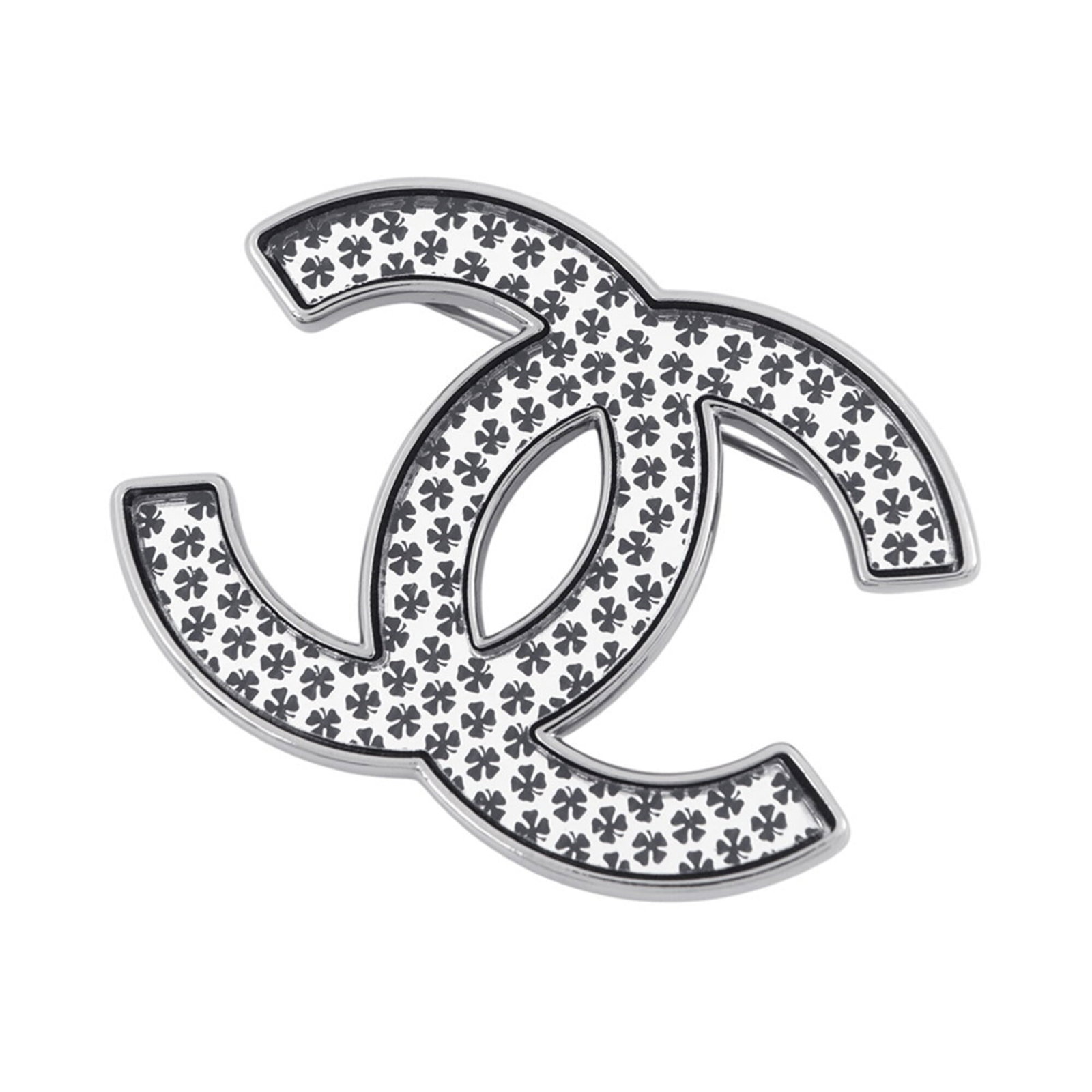 Metal brooch by Chanel: Metal brooch by Chanel The Chanel metal brooch boasts sleek, modern design with its black and silver finish. Made from high-quality metal, it measures 3.5cm x 4.7cm in size. A stylish accessory for th