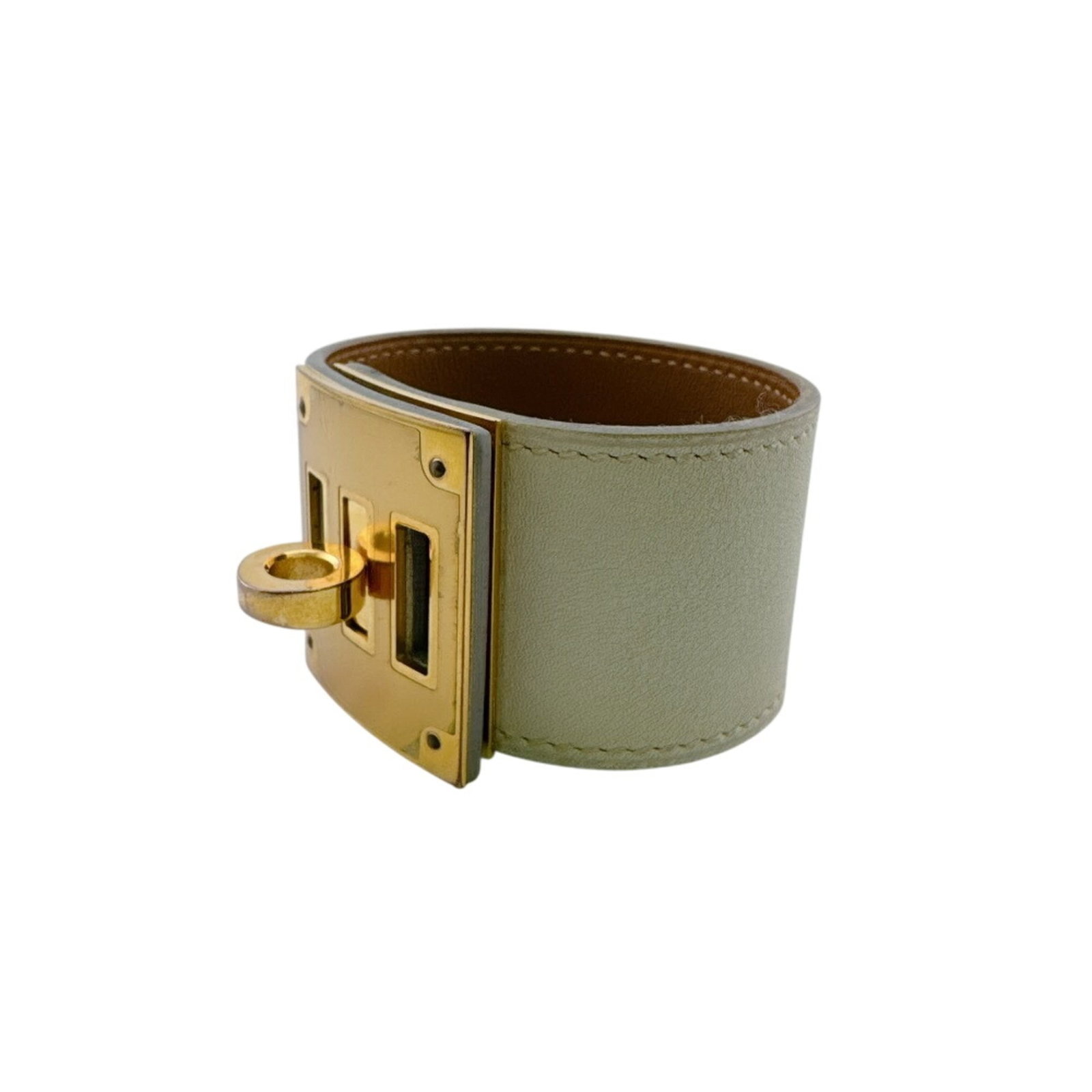 Metal Leather Bangle Hermes: Metal Leather Bangle Hermes Ivory metal and leather bangle from Hermes, measuring 19.3cm in length. This bangle combines the luxury of leather with the sophistication of metal craftsmanship. Its under