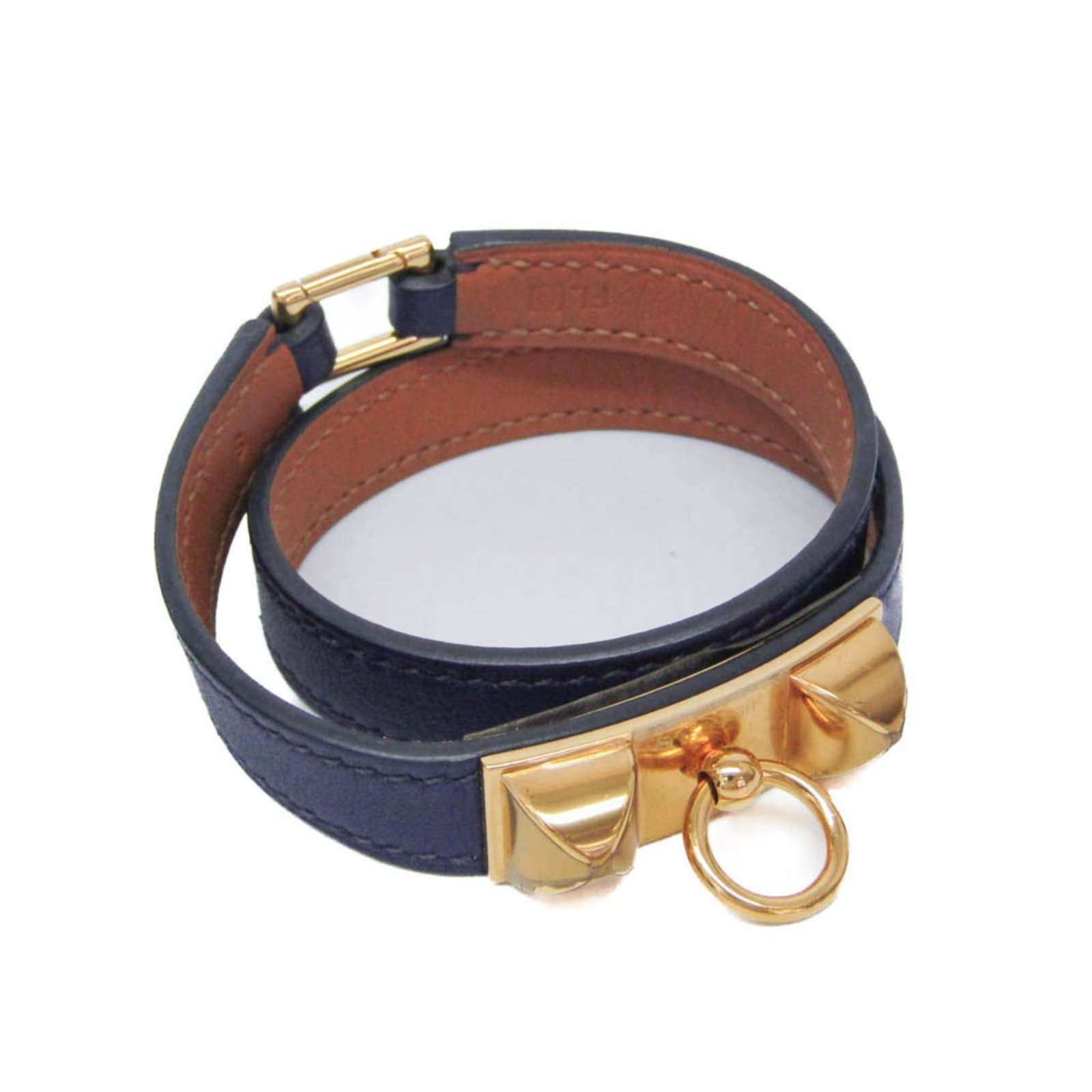 Metal leather wrap bracelet by Hermes: Metal leather wrap bracelet by Hermes Gold and navy leather wrap bracelet by Hermes, featuring a sleek double tour design. This stylish accessory boasts a luxurious gold metal finish and a comfortable