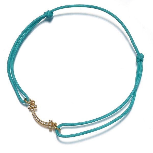 Tiffany&Co. Bracelet Diamond Tiffany T Smile 18K 750 Yellow Gold/ Cord: Tiffany&Co. Bracelet Diamond Tiffany T Smile 18K 750 Yellow Gold/ Cord Tiffany & Co.'s iconic 18K yellow gold Tiffany T Smile bracelet features a natural diamond set within its design, adding a touch 