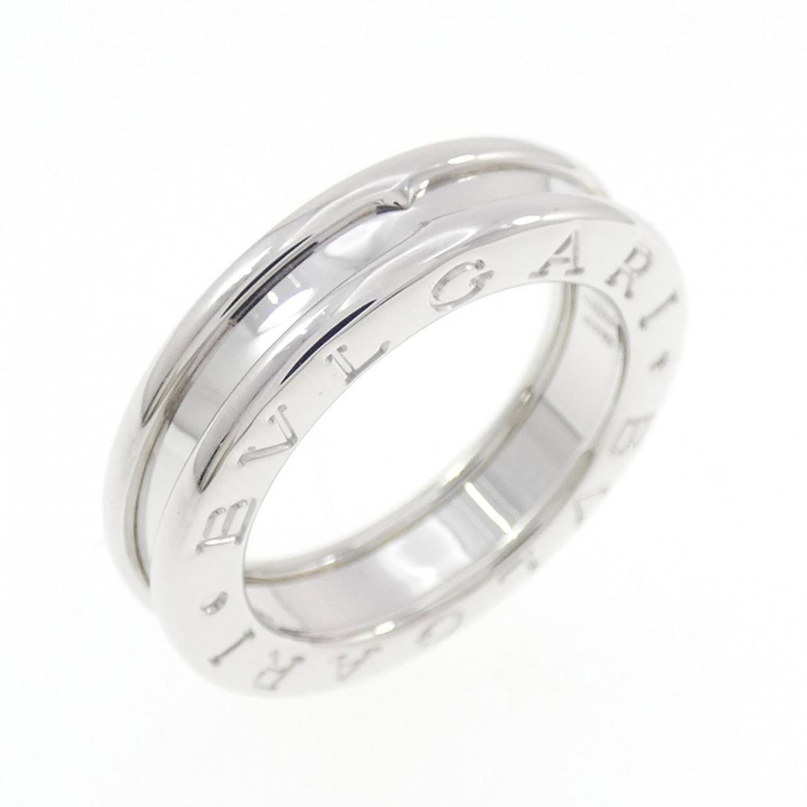 White Gold Bvlgari Ring Band: White Gold Bvlgari Ring Band White gold (18K) band ring from Bvlgari, available in US size 4. This elegant ring features the iconic Italian brand's signature style, crafted with high-quality white