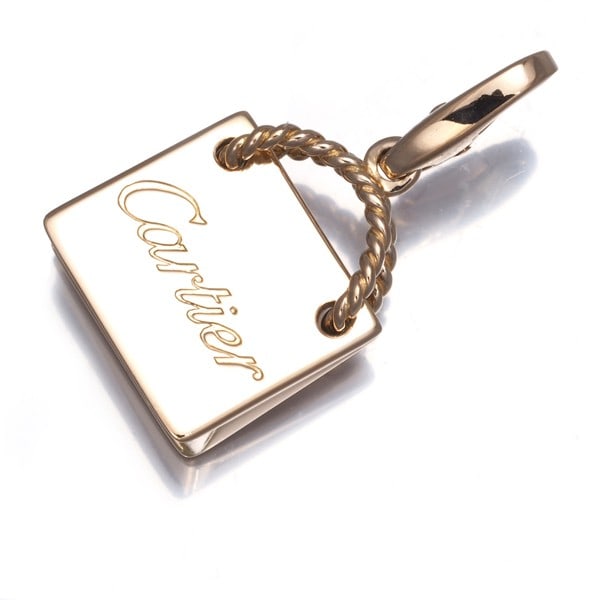 Pendant shopping bag charm gold 18k rose 750 Cartier: Pendant shopping bag charm gold 18k rose 750 Cartier 18k rose gold Cartier pendant charm, measuring 17.0 x 14.7mm in design size and weighing 4.7g, features a total length of the pendant including the