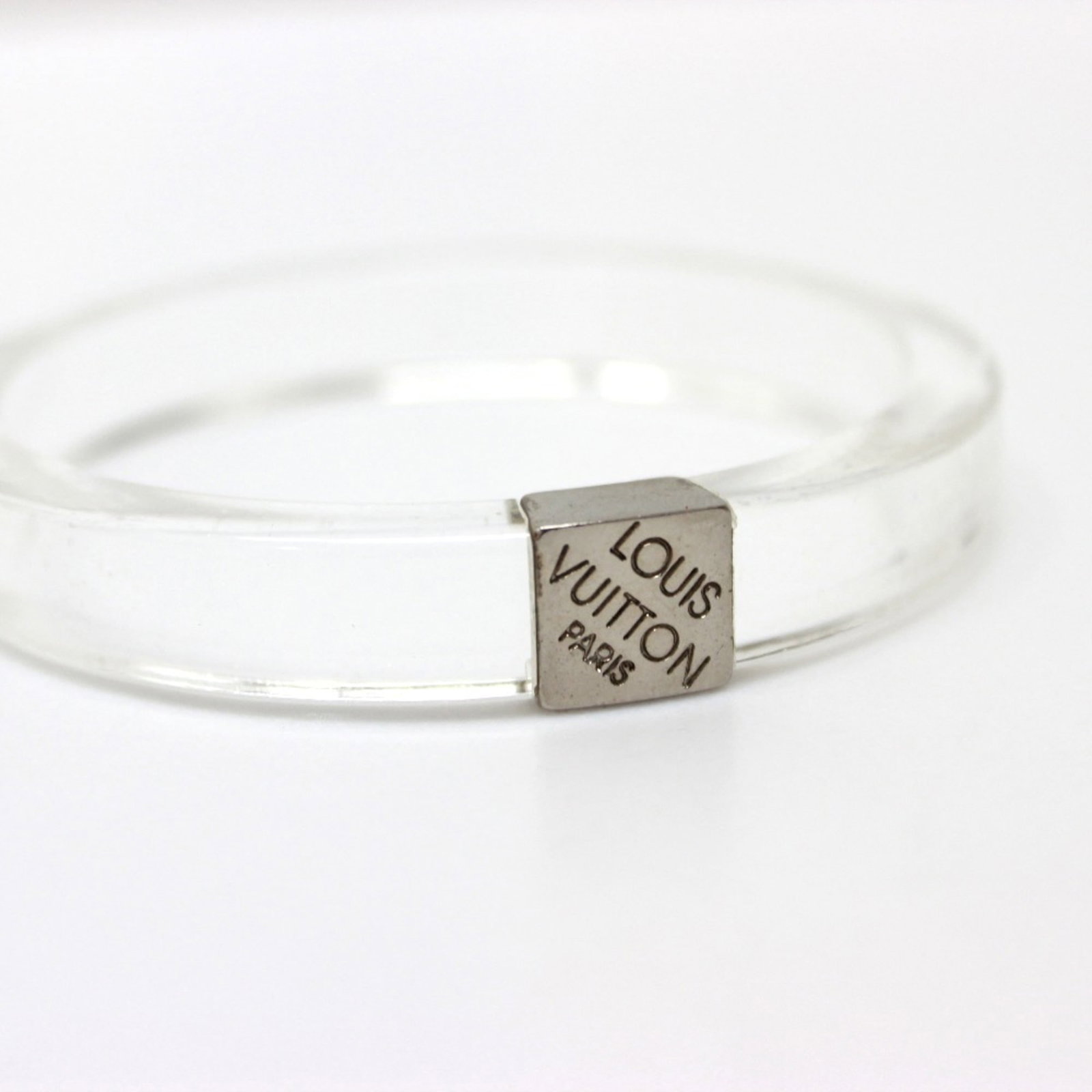 Bangle from Louis Vuitton: Bangle from Louis Vuitton This Louis Vuitton bangle boasts a sleek design with a band length of 7.5 inches and a width of 0.4 inch, making it a stylish accessory for women. The bangle's material and