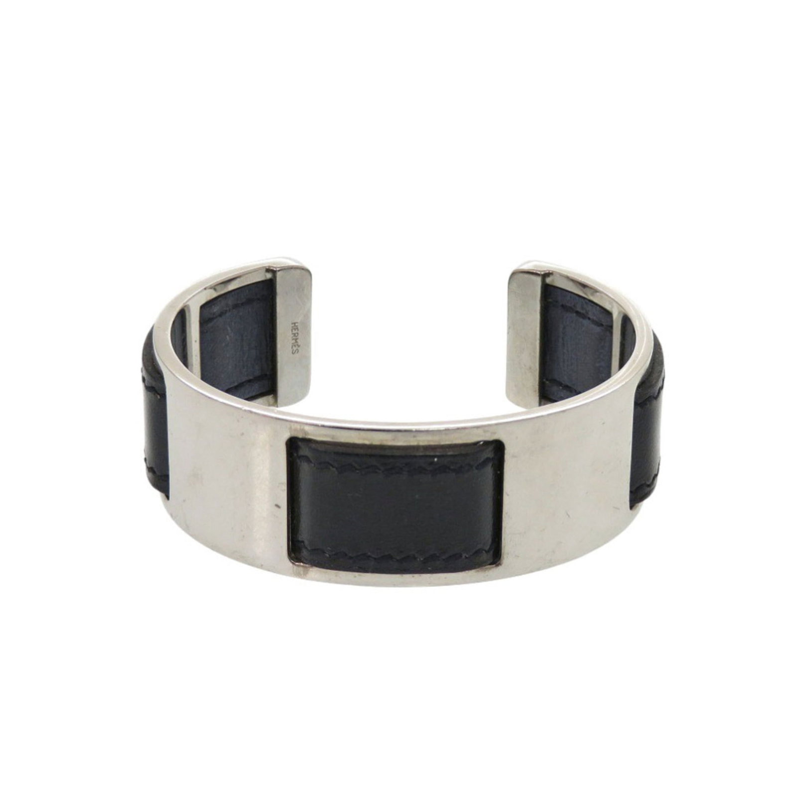 Metal Leather Bangle Hermes: Metal Leather Bangle Hermes Metal Leather Bangle by Hermes, featuring black leather and silver accents, measures 15.5cm in length. This bangle showcases a unique combination of materials, with the con