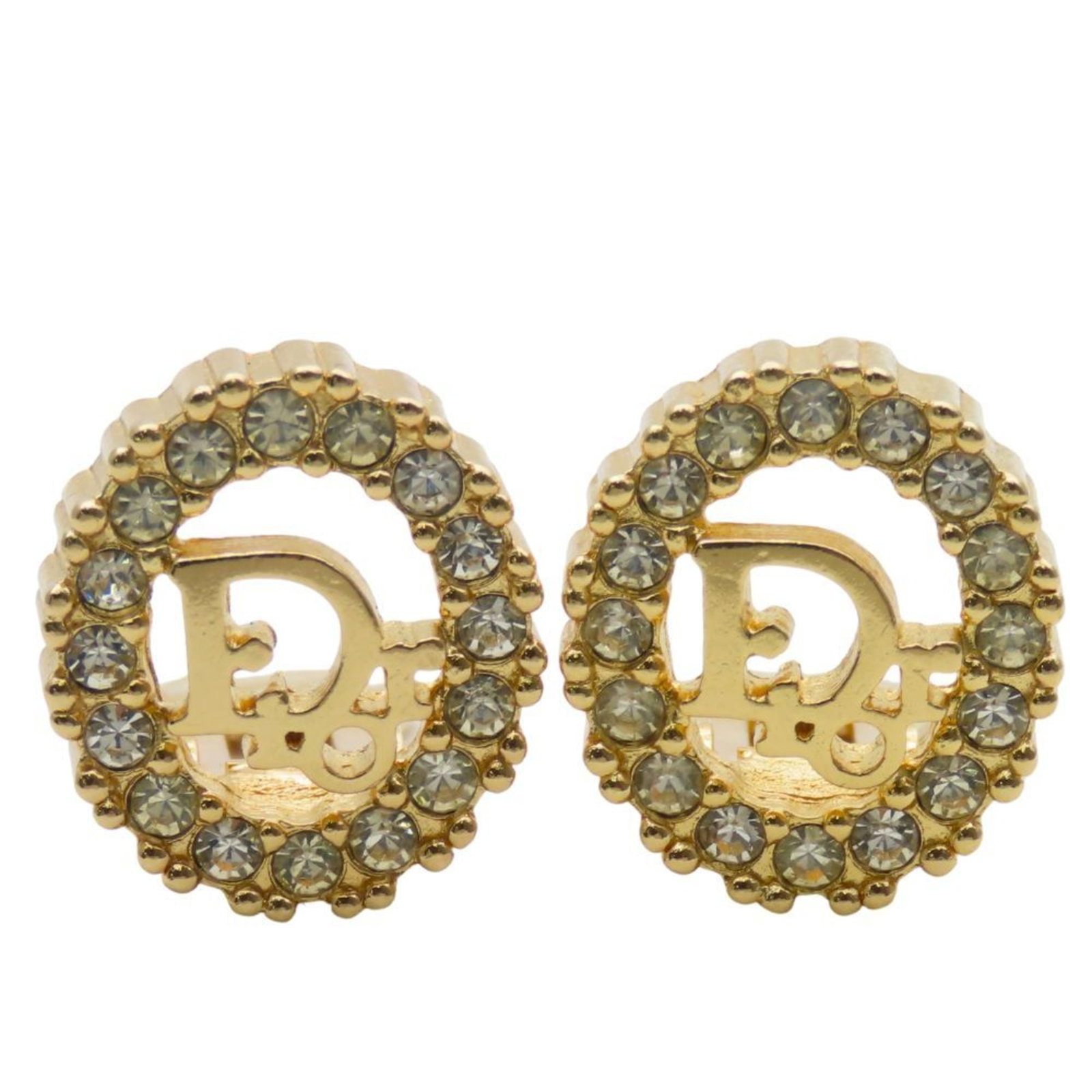 Clip earrings in metal by Christian Dior: Clip earrings in metal by Christian Dior Clip earrings in gold metal by Christian Dior feature rhinestone stones. The sleek design showcases the signature style of the luxury brand, with a compact siz
