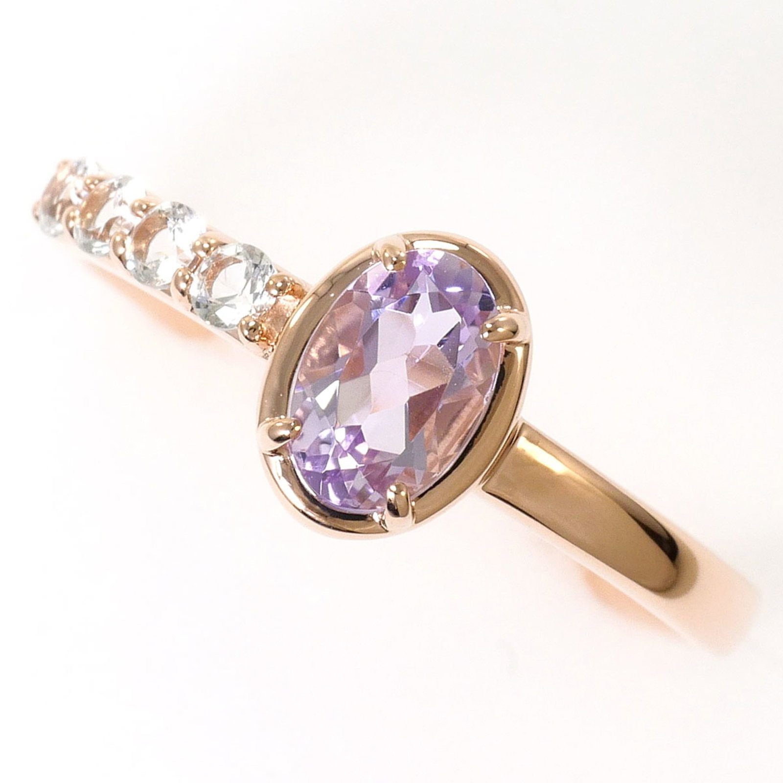 Unbranded Band Ring Pink Gold (10K): Unbranded Band Ring Pink Gold (10K) Pink gold band ring featuring an amethyst and topaz stone, crafted from 10K pink gold metal. The ring measures 5.5 in US size with a width of 7mm and weighs 1.3g. I