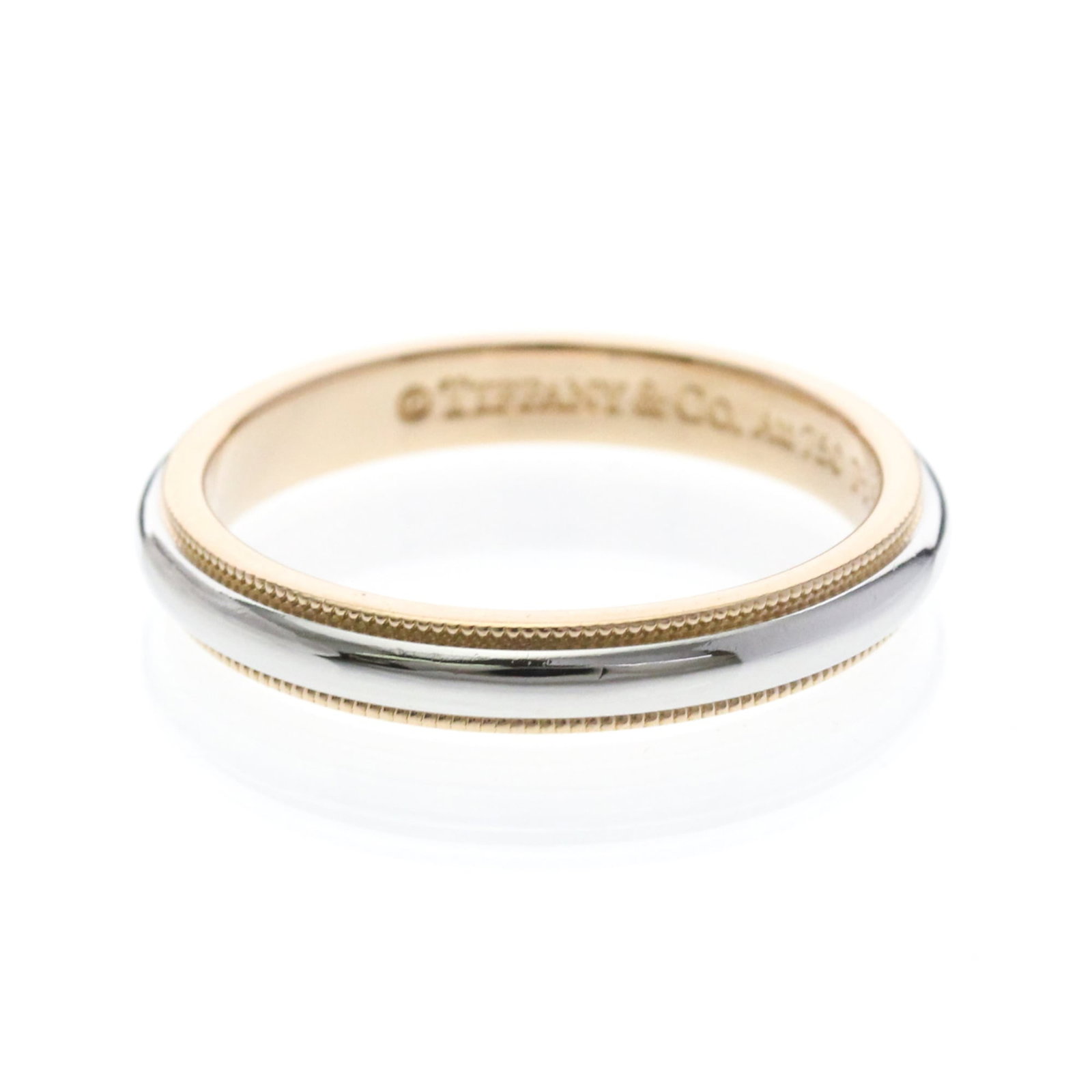 Pink Gold Ring Tiffany Band Platinum: Pink Gold Ring Tiffany Band Platinum Pink gold band ring with intricate milgrain details, crafted from 18K pink gold and platinum metal. This stylish fashion accessory features a sleek design and a su