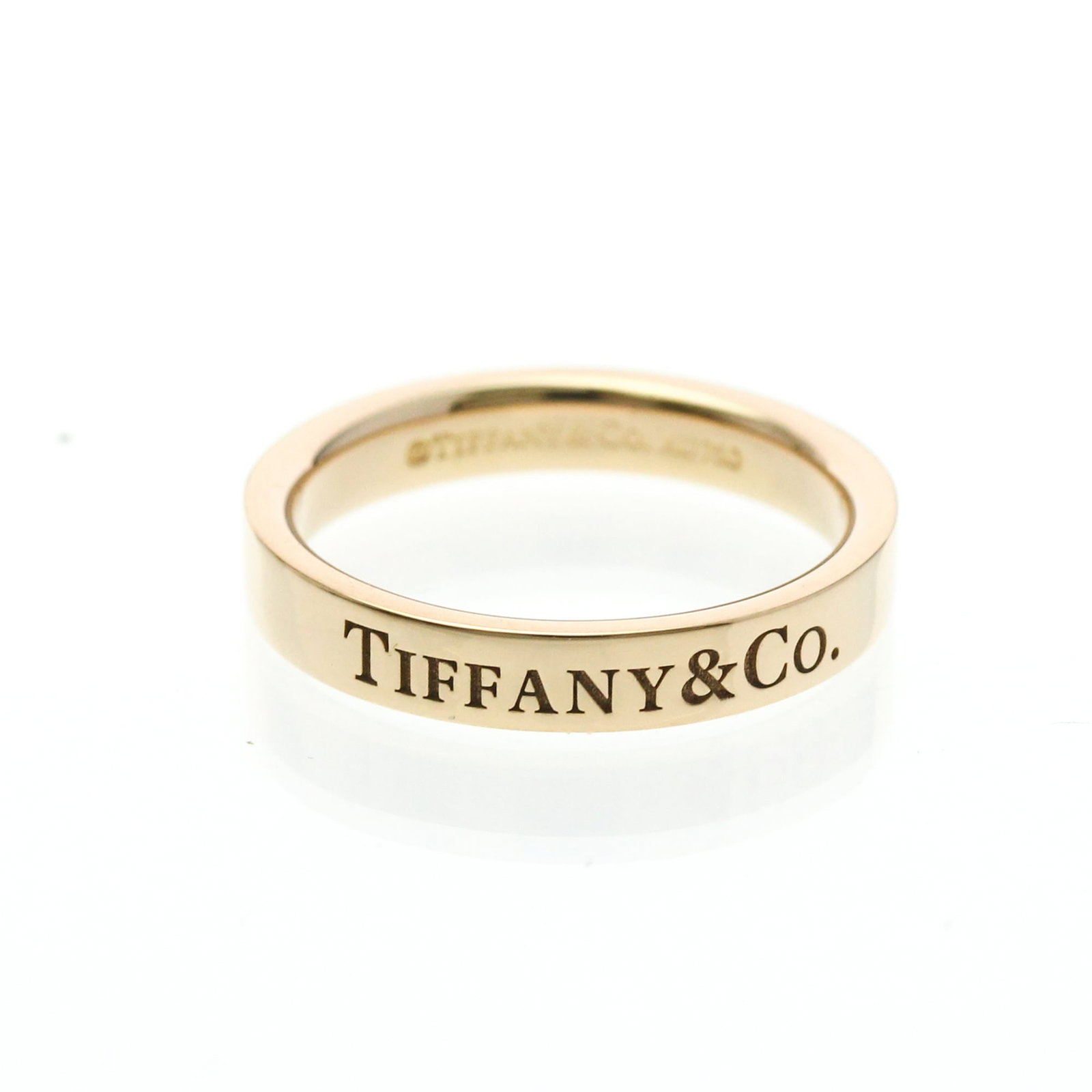 Pink Gold Tiffany Ring Band: Pink Gold Tiffany Ring Band Pink gold Tiffany ring band, crafted from 18K pink gold metal, features a flat band style with a width of 2.9mm and weighs 3g. This elegant fashion accessory boasts a