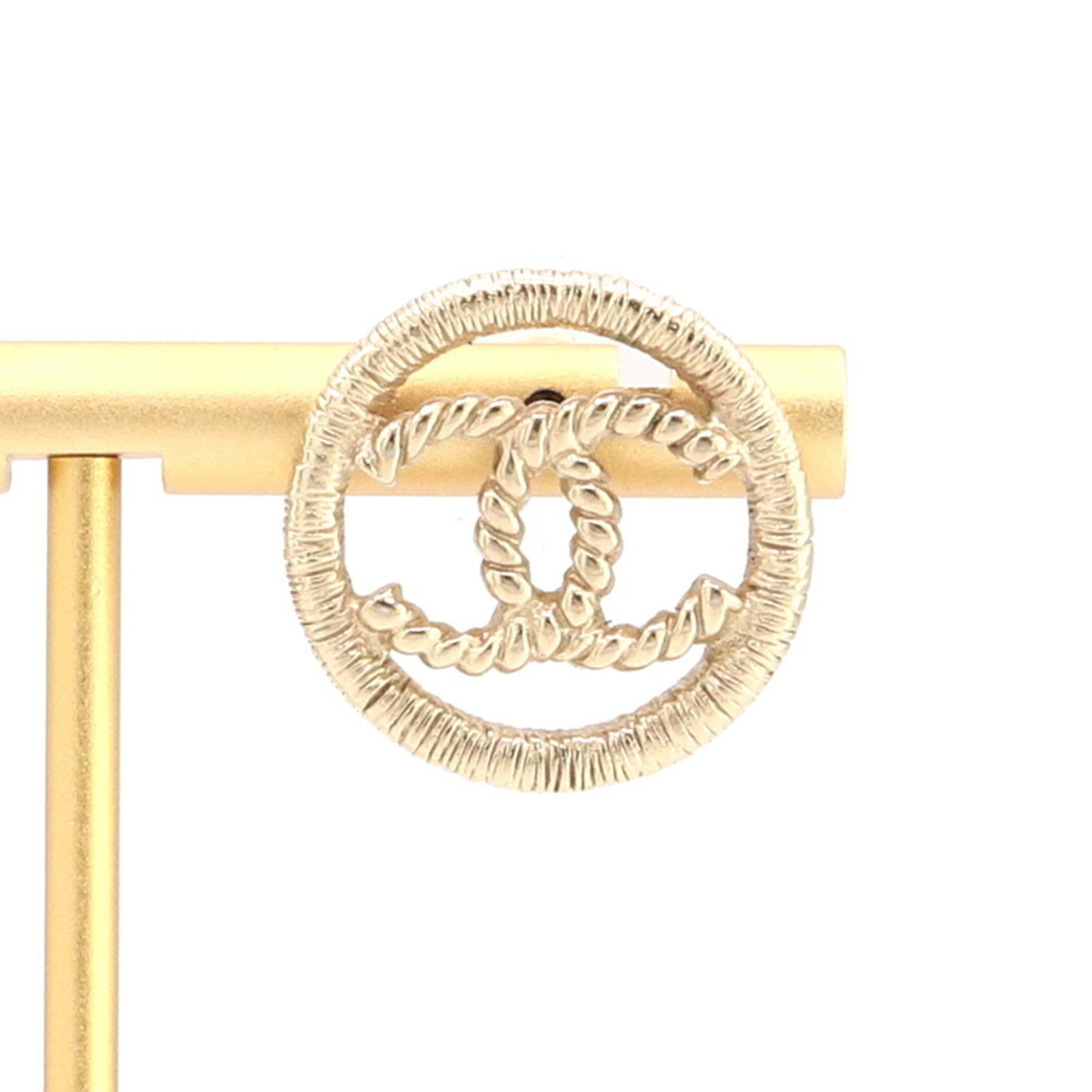 Metal earrings by Chanel: Metal earrings by Chanel Champagne gold metal earrings by Chanel, presented in a luxurious box. These stud earrings showcase the iconic brand's attention to detail and timeless design. A beautiful add