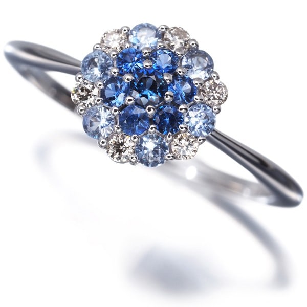 Sapphire Diamond Paved Flower Ring 18K 750 White Gold: Sapphire Diamond Paved Flower Ring 18K 750 White Gold 18k white gold pav? set with a sapphire and diamond, this elegant ring showcases intricate craftsmanship. The natural stone carat weight is unmark