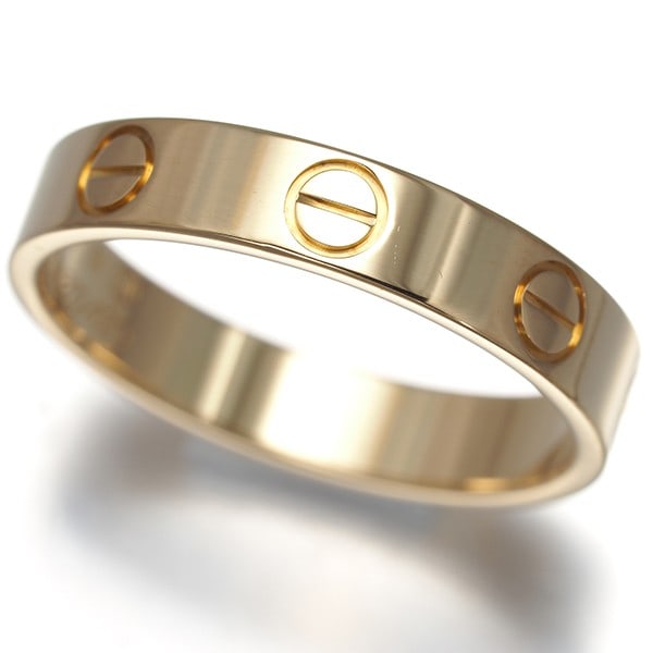 Cartier Ring Love Sm Eu51 18K 750 Yellow Gold: Cartier Ring Love Sm Eu51 18K 750 Yellow Gold Cartier's iconic Love Ring in 18k yellow gold boasts a sleek, band-style design with a subtle yet elegant presence. This timeless piece features a ring si