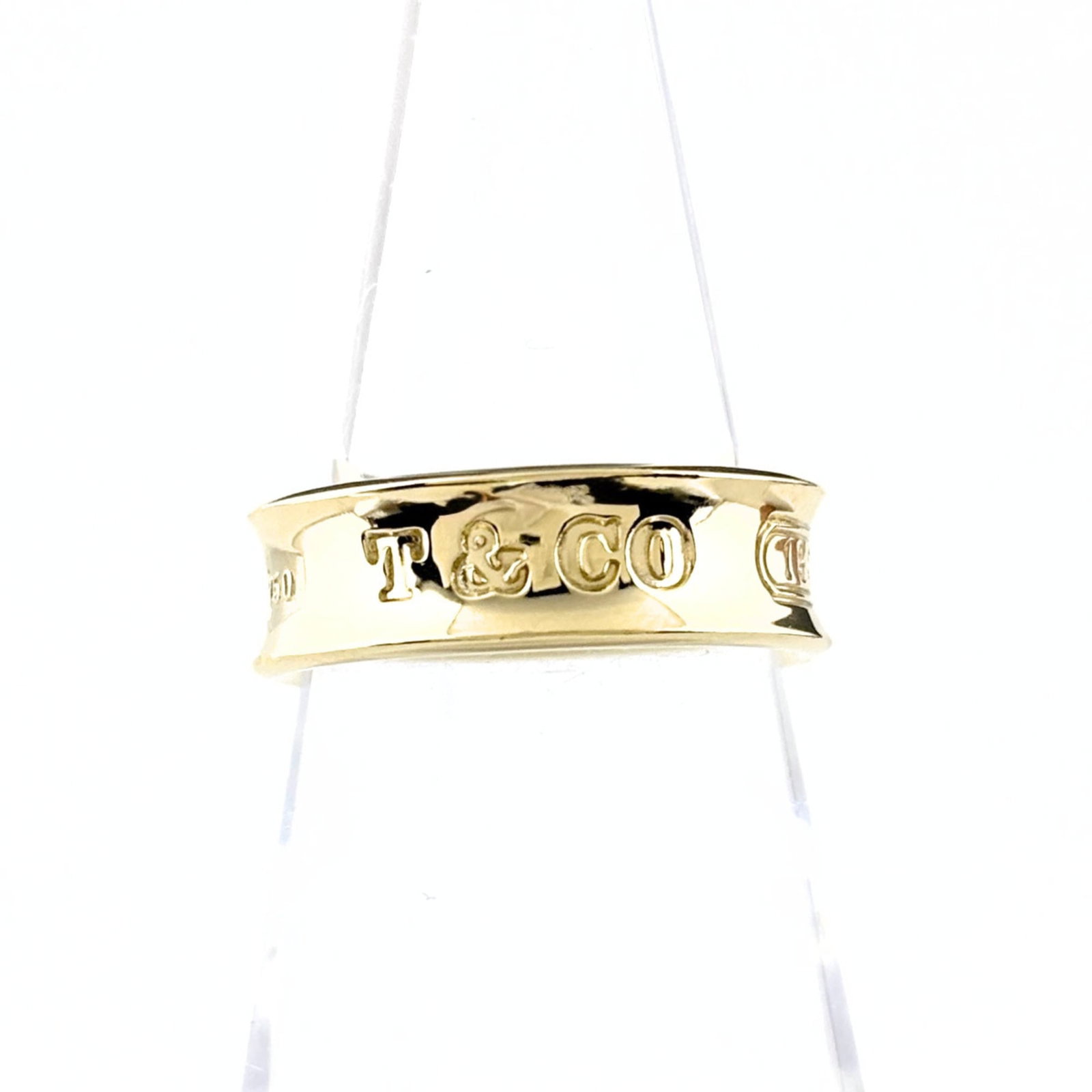 Yellow Gold 18K Tiffany Band Ring: Yellow Gold 18K Tiffany Band Ring Yellow gold (18K) band ring with a classic design, available in US size 5.5. This Tiffany brand ring features a durable and luxurious yellow gold material that adds