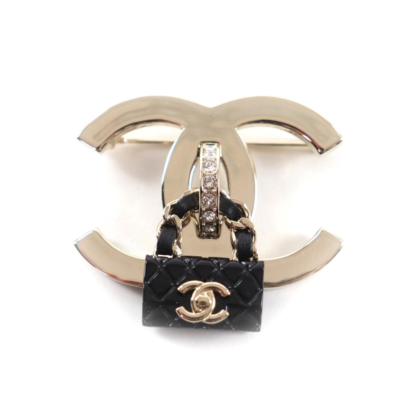Chanel Brooch: Chanel Brooch Black and gold Chanel brooch with dimensions 4.5cm x 5cm, bearing the MPN B23C. This piece showcases a sleek design that highlights its size and color. The brooch is made from materials