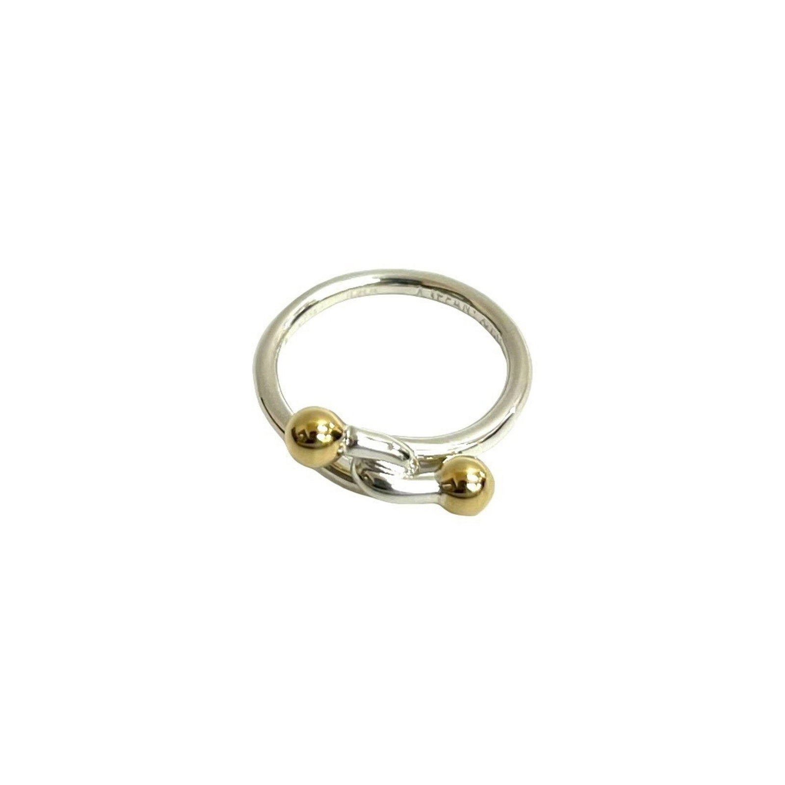 Tiffany Band Ring Silver 925 Yellow Gold (10K): Tiffany Band Ring Silver 925 Yellow Gold (10K) Silver and yellow gold (10K) come together in this elegant band ring from Tiffany, crafted with 925 silver. The US size 4 design makes it a versatile acc