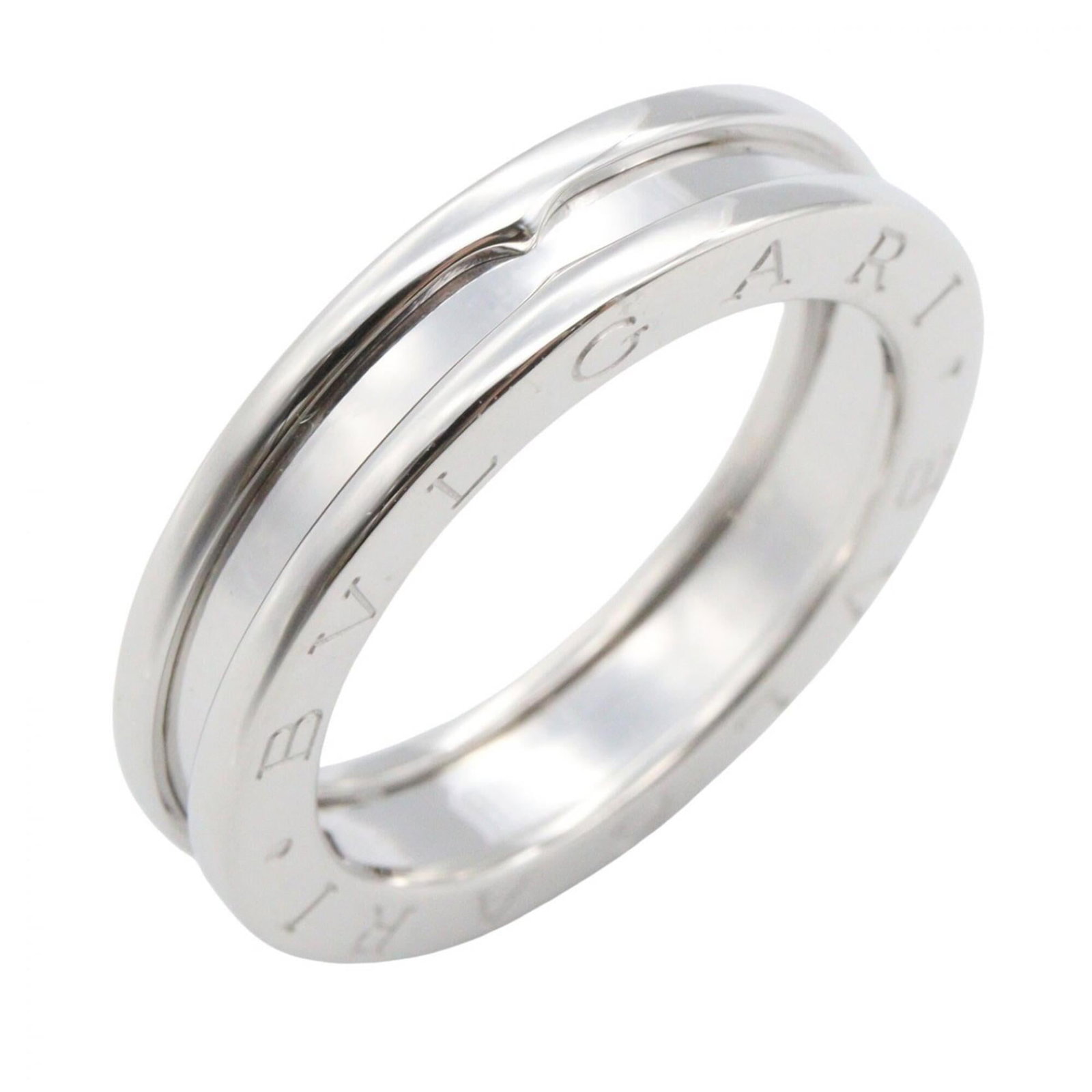 White Gold Bvlgari Ring Band: White Gold Bvlgari Ring Band White gold (18K) band ring from Bvlgari, available in US size 6.5 and featuring the iconic brand's signature style. This elegant silver ring showcases the luxury of white