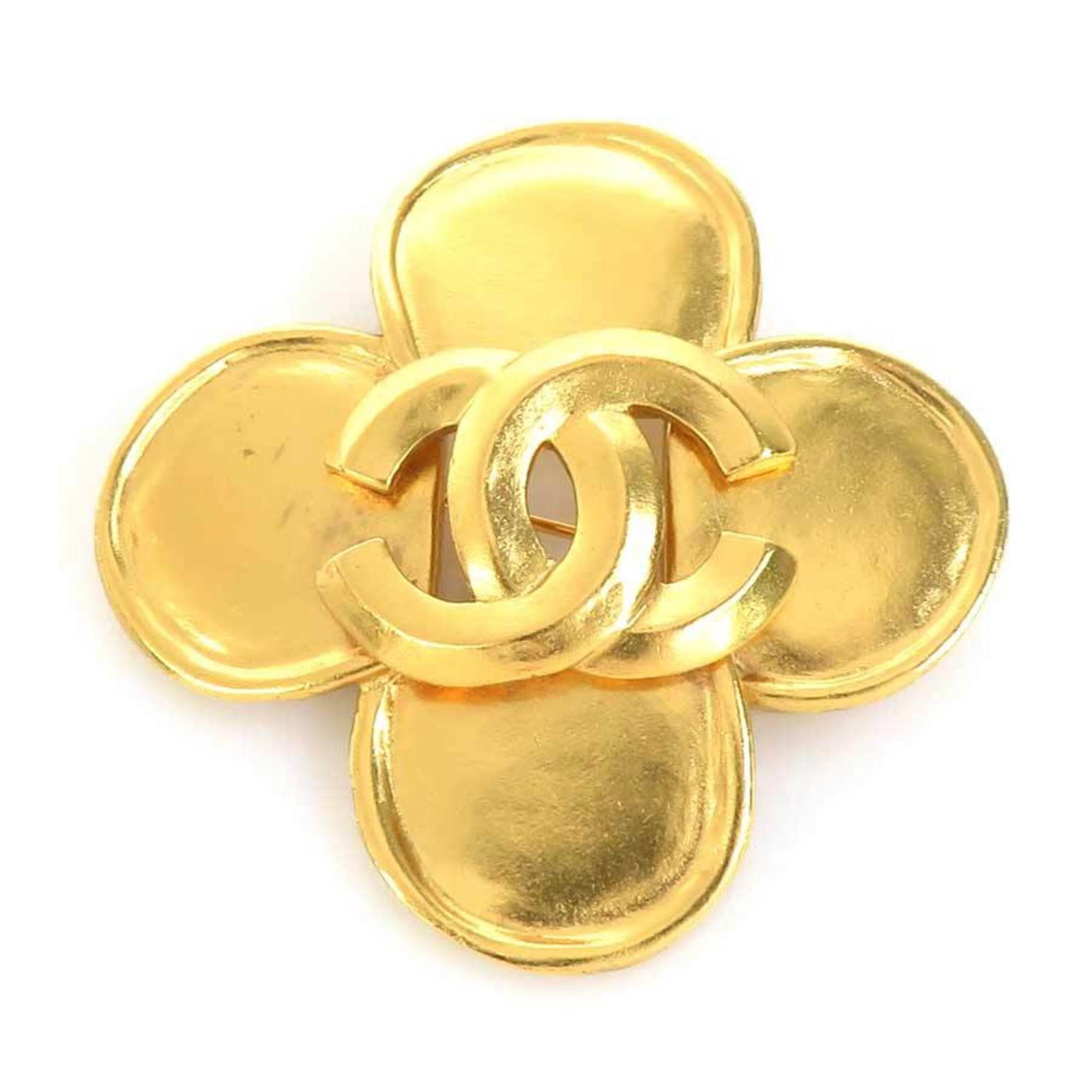 Metal brooch by Chanel: Metal brooch by Chanel This gold metal brooch by Chanel features a sleek design, showcasing the iconic brand's signature style. Made in France, it boasts a compact size and simple aesthetic,