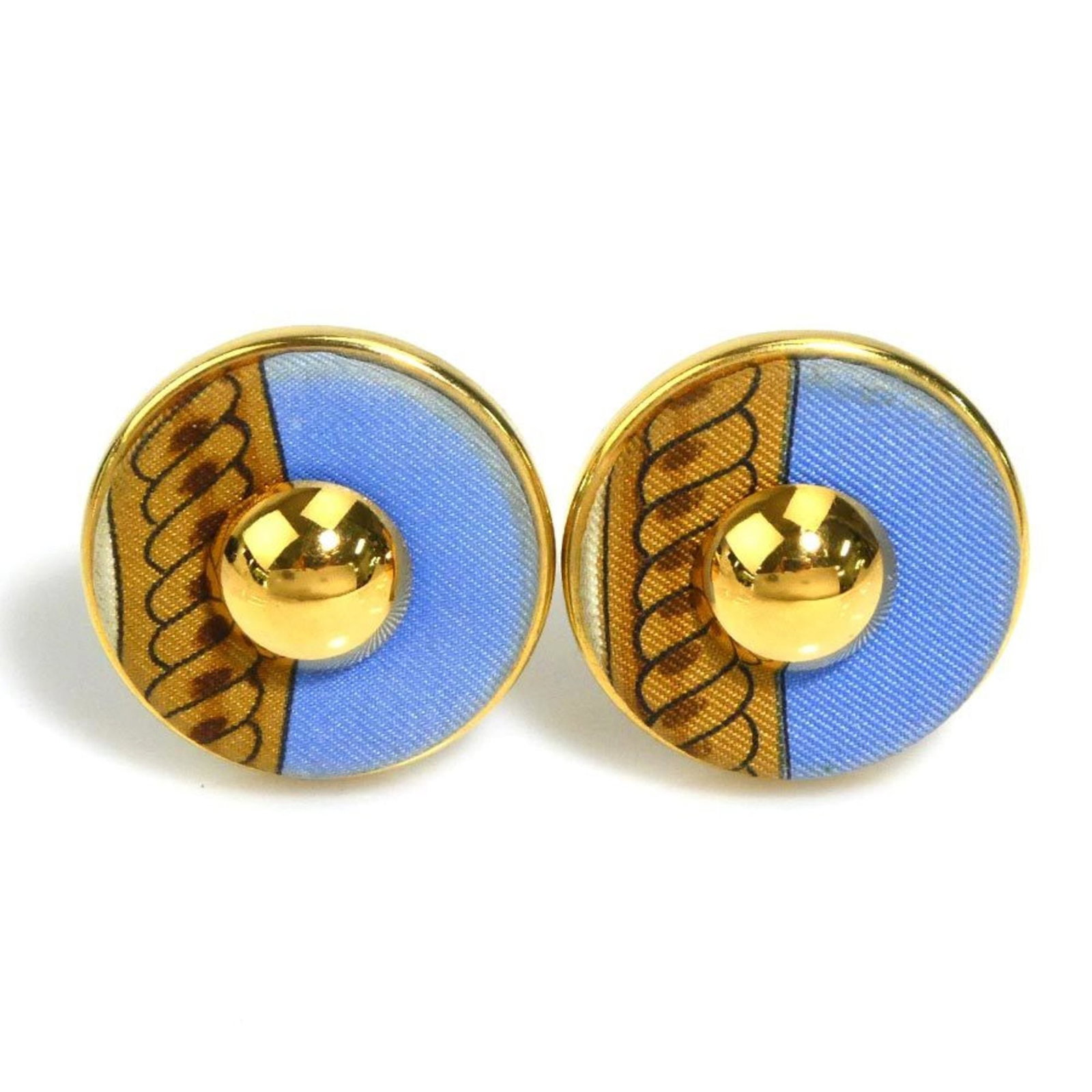 Hermes Clip Metal Silk Earrings: Hermes Clip Metal Silk Earrings Clip earrings from the iconic French fashion house Hermes, crafted in metal and adorned with intricate silk details. Available in blue, brown, and gold hues, these