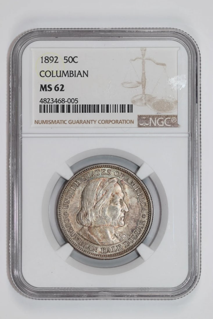 COLUMBIAN HALF DOLLAR NGC MS62 COMMEMORATIVE 1892: COLUMBIAN HALF DOLLAR NGC MS62 COMMEMORATIVE 1892 NGC MS62 certified Colombian Half Dollar commemorating the 1892 event, bearing a signature. This silver coin features a striking design and a notable 