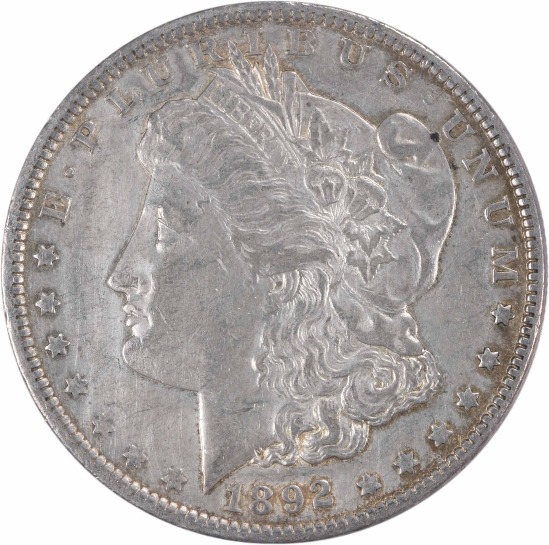 Uncertified AU 1892 Morgan Silver Dollar: Uncertified AU 1892 Morgan Silver Dollar The 1892 Morgan Silver Dollar is a circulated coin with an AU grade, featuring George T. Morgan's iconic design and a reeded edge. Made from 90% silver and 10%