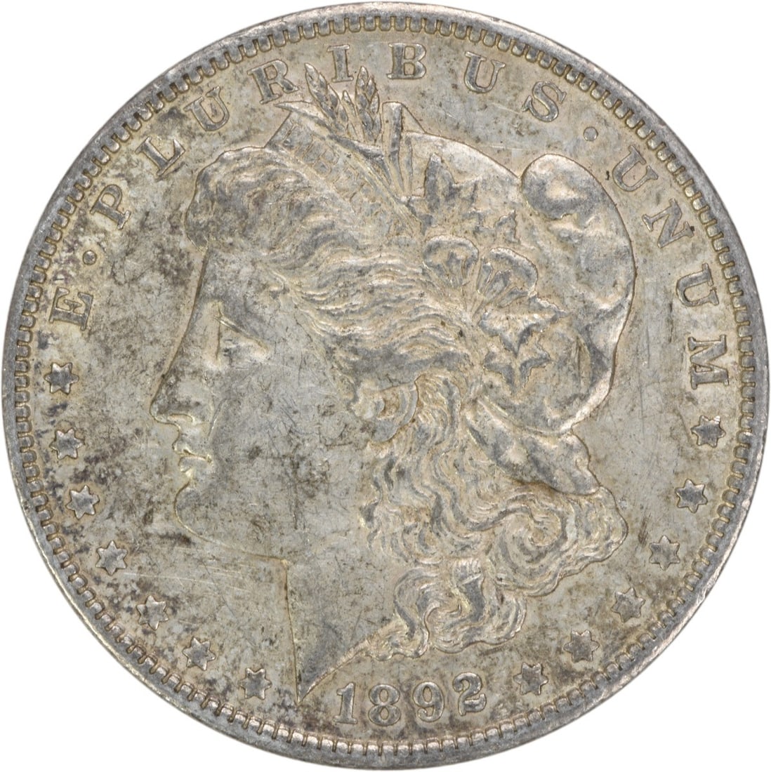 1892-O Morgan Silver Dollar AU Uncertified: 1892-O Morgan Silver Dollar AU Uncertified The 1892-O Morgan Silver Dollar features George T. Morgan's iconic design, showcasing the Reeded edge and the distinctive 'O' mint mark from New Orleans. Mad