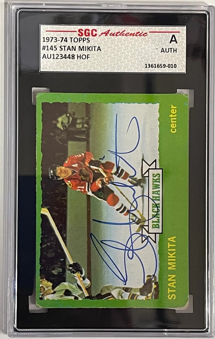Stan Mikita Autographed 1973-74 Topps Card #145 (SGC): Stan Mikita Autographed 1973-74 Topps Card #145 (SGC) SGC Stan Mikita Autographed 1973-74 Topps Card #145 features the iconic hockey player's name and likeness, paired with a verified autograph on the