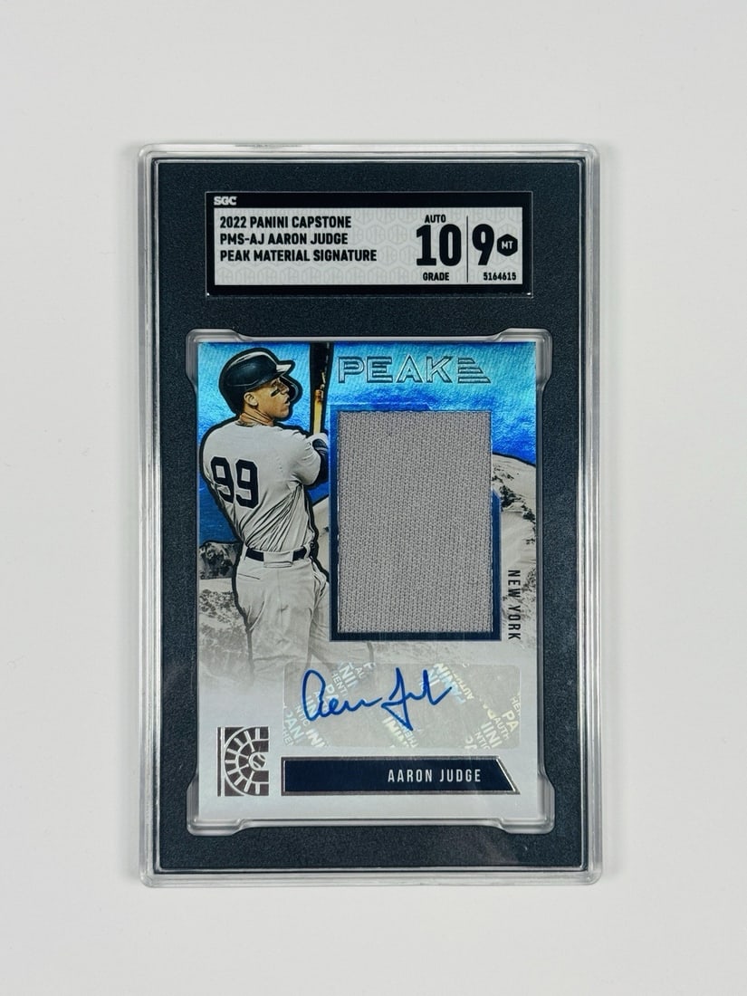 2022 PANINI CAPSTONE AARON JUDGE #PMS-AJ PEAK MATERIAL SIGNATURE SGC 9 AUTO 10: 2022 PANINI CAPSTONE AARON JUDGE #PMS-AJ PEAK MATERIAL SIGNATURE SGC 9 AUTO 10 Standard League MLB autographed card featuring Aaron Judge, graded by SGC to an 10. The card bears the signature of Aaron