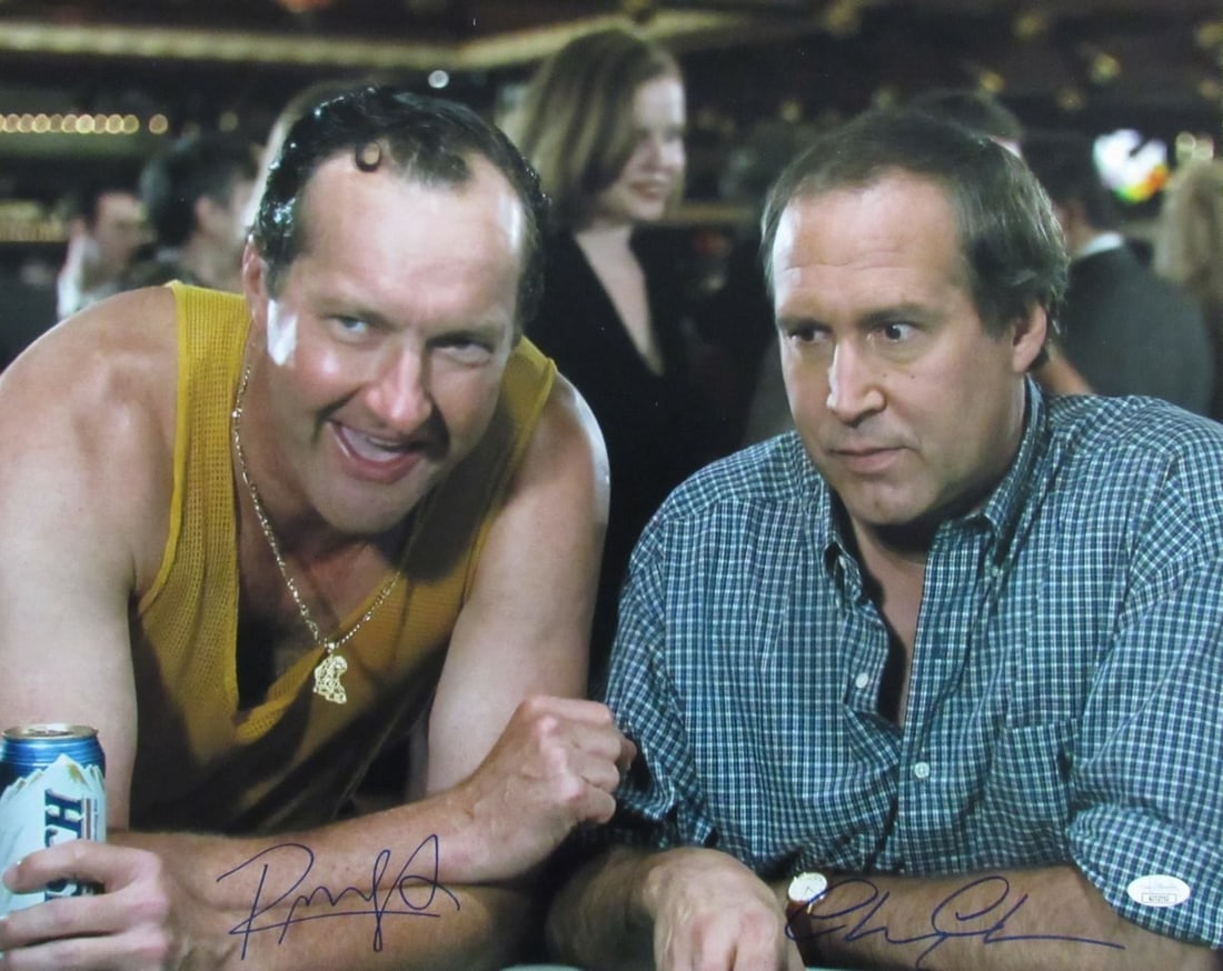 Chevy Chase/ Randy Quaid Autographed 16x20 Photo "Vegas Vacation" JSA 179126: Chevy Chase/ Randy Quaid Autographed 16x20 Photo "Vegas Vacation" JSA 179126 Chevy Chase and Randy Quaid star in this iconic photo from the 1997 comedy classic "Vegas Vacation". The 16x20 inch signed 