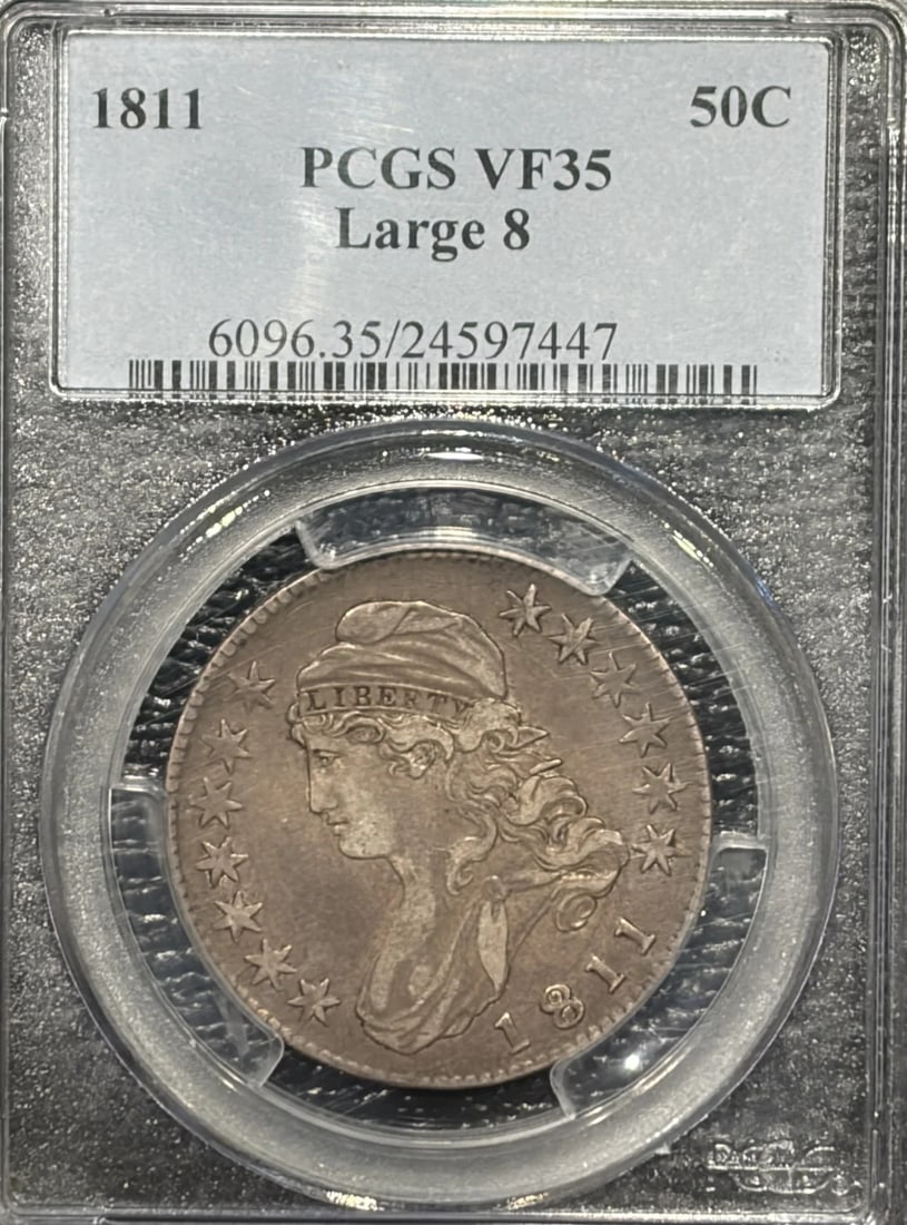 1811 LARGE 8 BUST HALF DOLLAR PCGS VF35: 1811 LARGE 8 BUST HALF DOLLAR PCGS VF35 This 1811 Large 8 Bust Half Dollar, certified by PCGS as VF35, showcases a well-preserved silver coin from the early years of American currency. With its distin